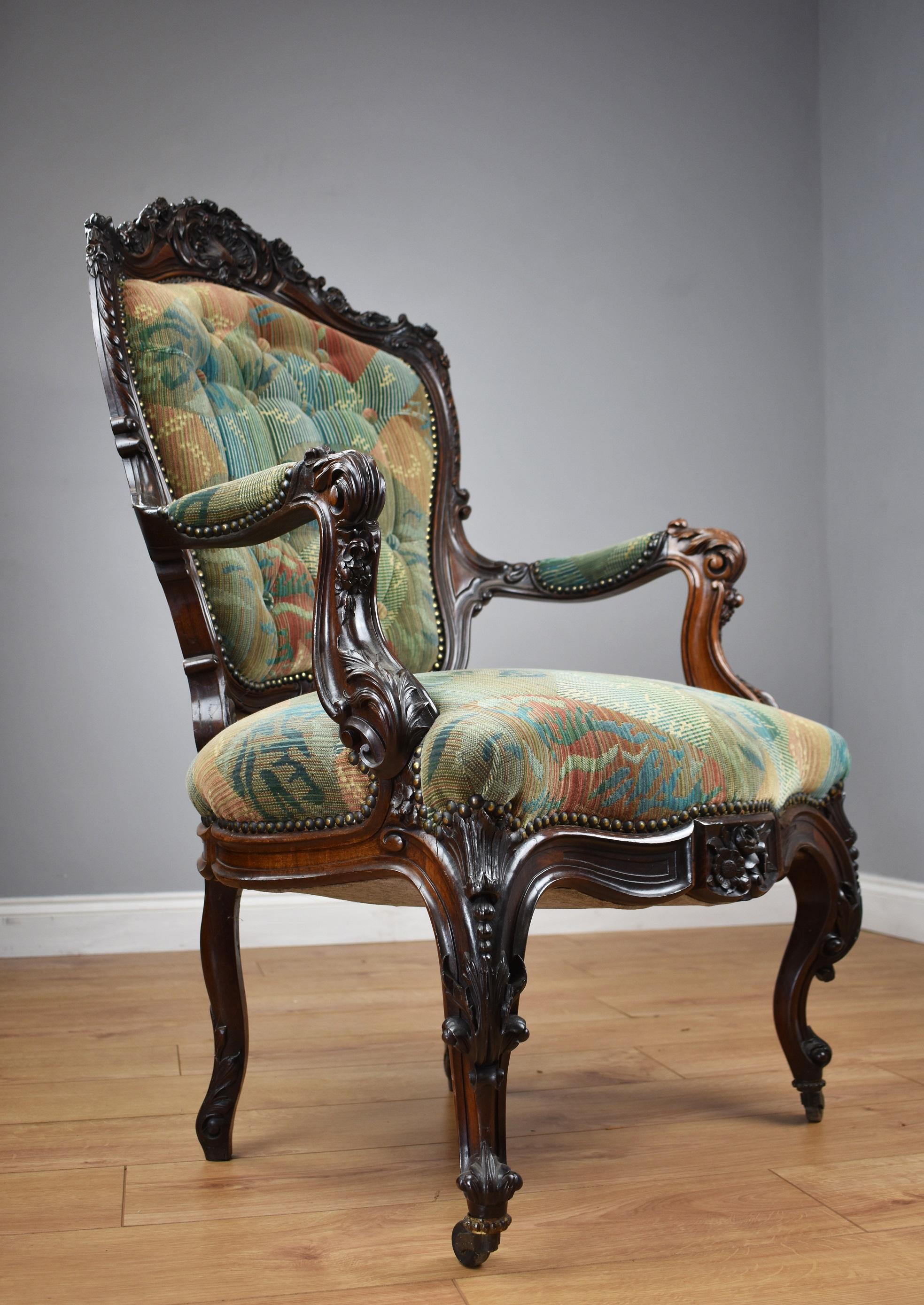 For sale is a fine quality Victorian solid rosewood show frame armchair, having an ornately shaped and carved back above upholstered seat, with two carved arm arms. The chair stands on elegant legs at the front, also profusely carved, with two
