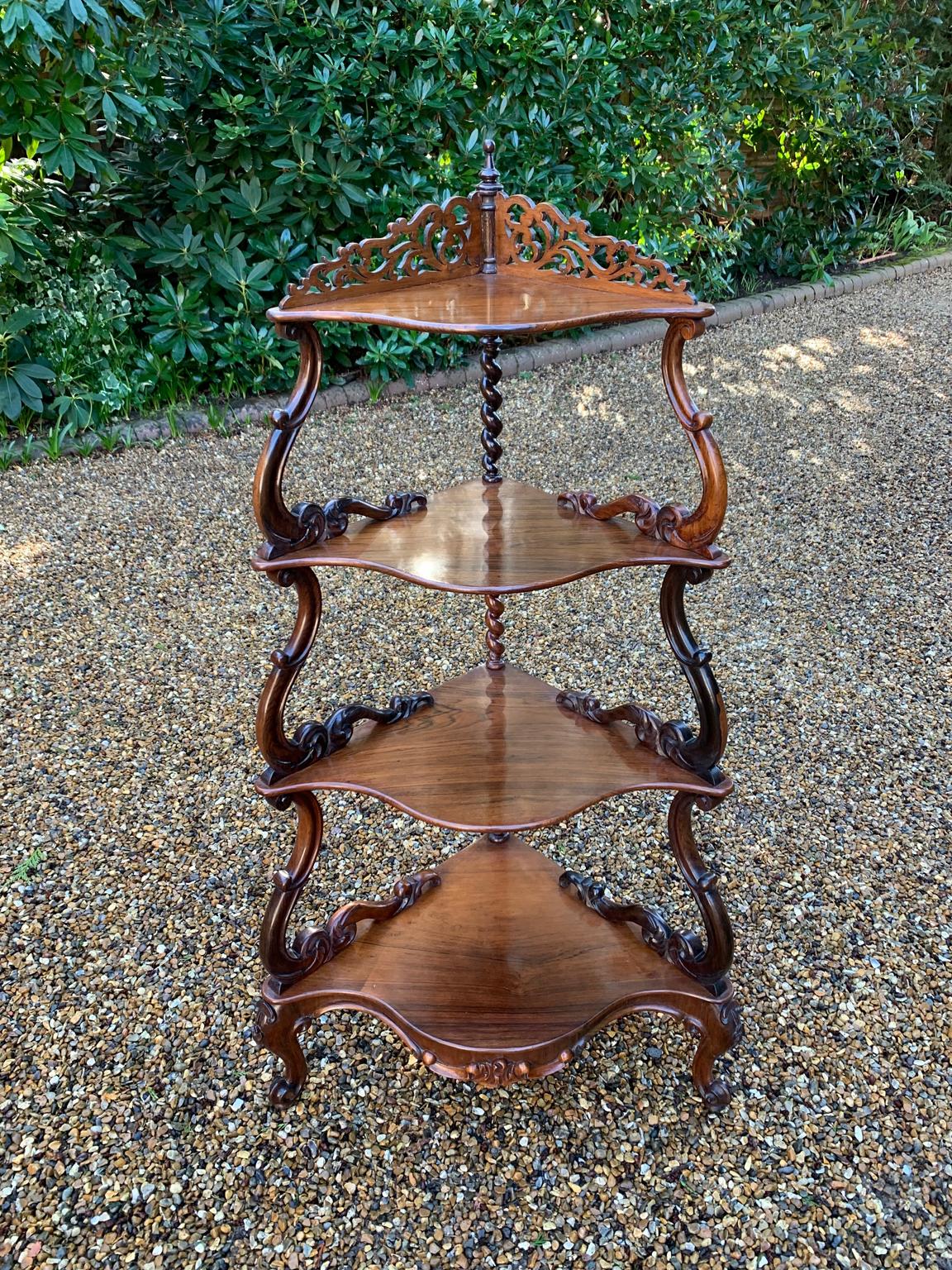 19th Century Victorian Rosewood Corner Whatnot, with a fret carved gallery over four serpentine tiers raised on turned spiral columns, all standing on cabriole legs.

Circa: 1835.