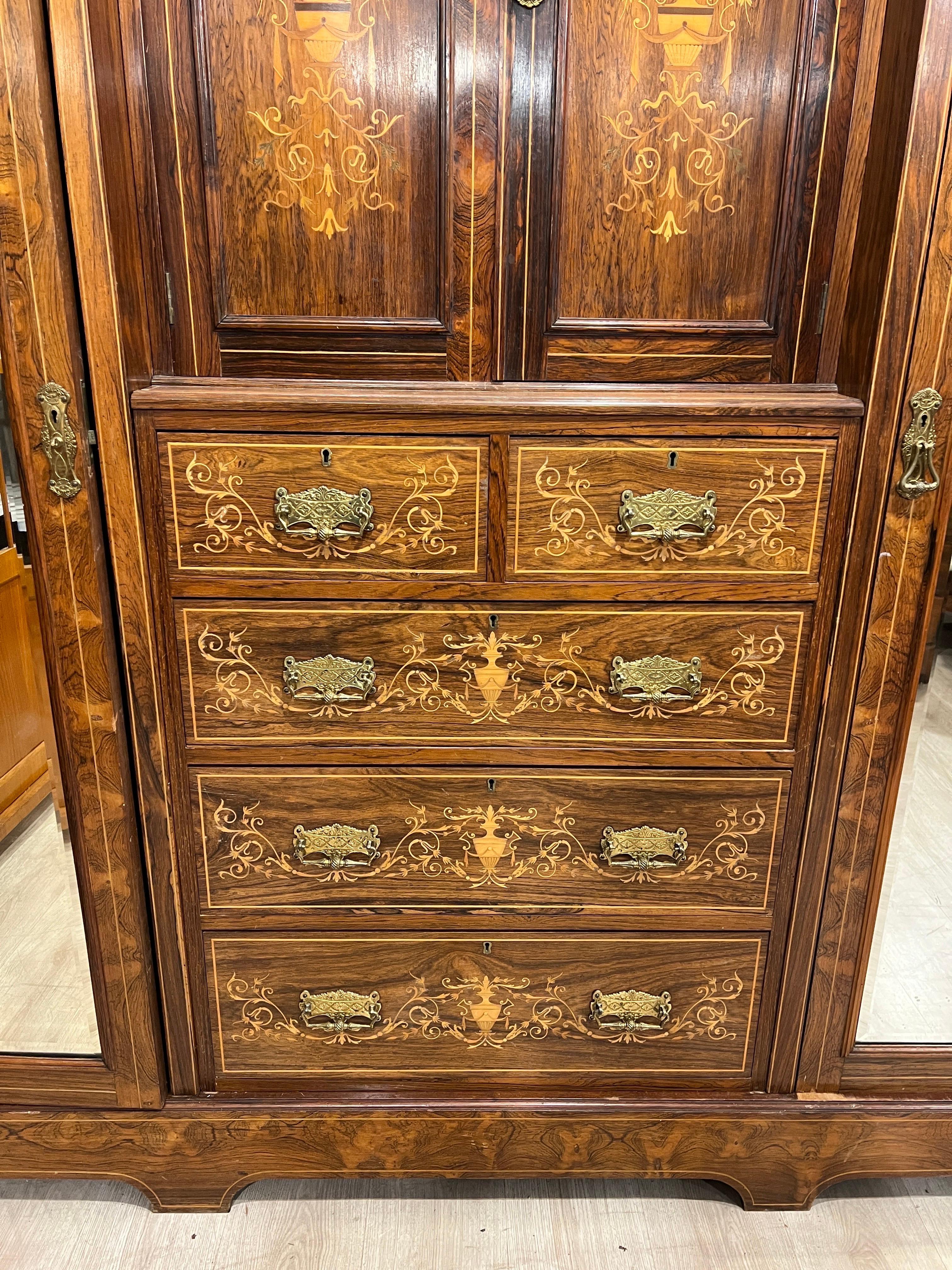 English cabinet made of rosewood and inlaid with boxwood in floral motifs, Victorian era , beautifully crafted and made by the famous Maple&C° cabinet-making firm of London. Counted among the best in woodworking and for creating furniture that will