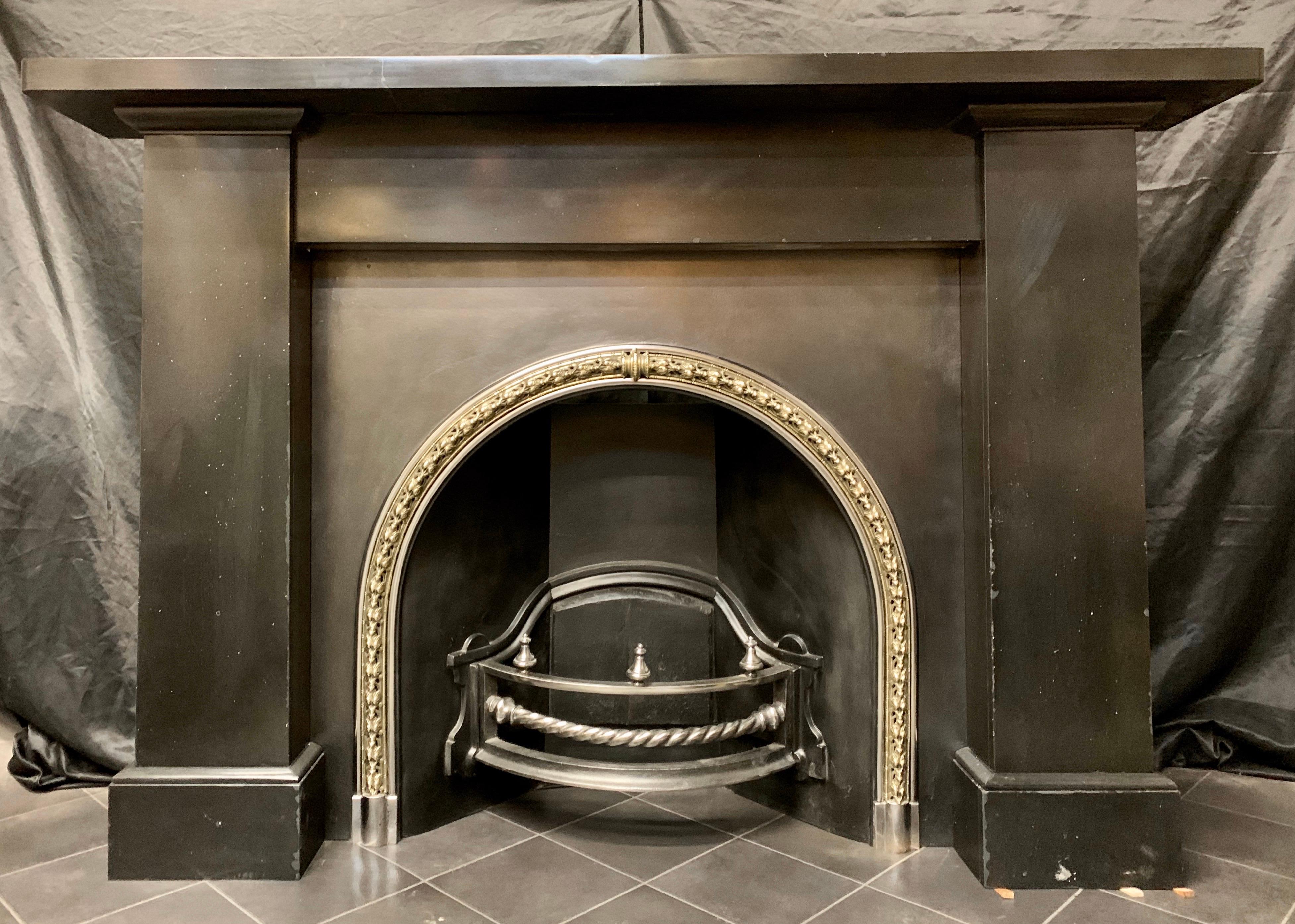 A large and masculine 19th century Scottish (Edinburgh circa 1850) Belgian black marble fireplace surround. A substantial square shelf sits above an unadorned frieze, flanked by tall jambs both with profiled capping's to the top, all resting on to