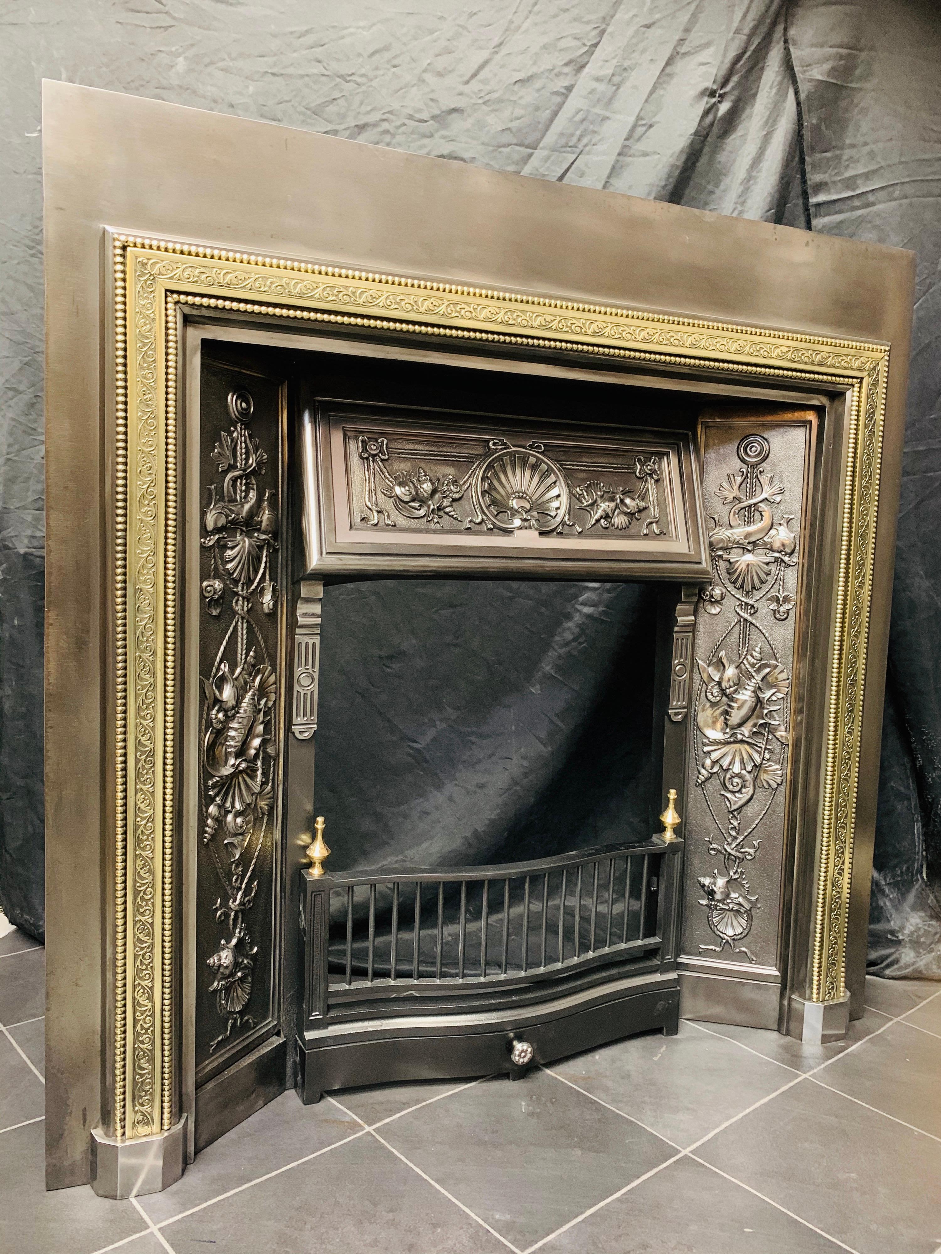 A large 19th century high Victorian Scottish brass and polished cast iron fireplace Insert of the finest quality. A large outer frame with an applied raised border of leaf tendrils flanked by dragooned repeating balls all in polished brass,
