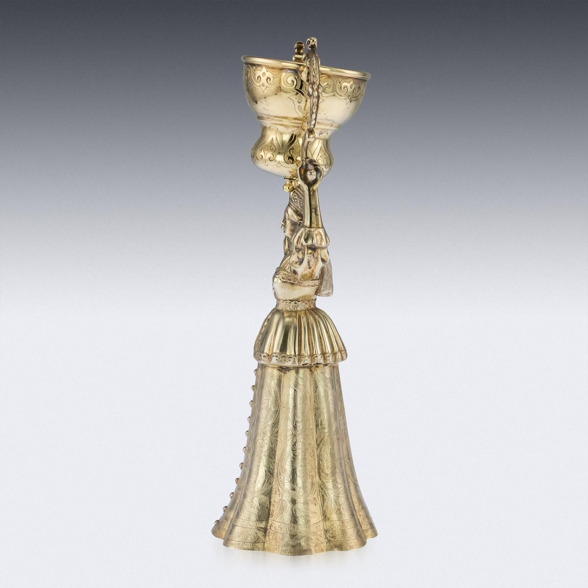 Antique 19th century Victorian solid silver-gilt Wager / Marriage cup, the cups design inspired by the early 16th century German example, modelled as a female figure supporting over her head a smalled domed swiveling cup and the lower cups half