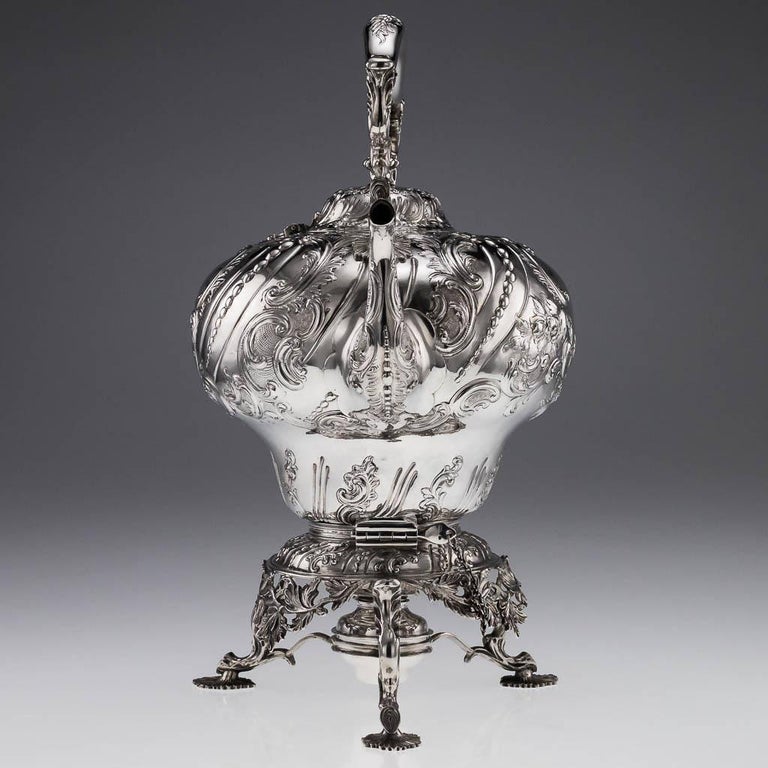 Antique mid-19th century Victorian solid silver tea kettle on a three feet burner stand, impressively large and very heavy (twice the size as a usual one), the swirl fluted body is chased with scrolls, beads and flowers, the domed hinged cover