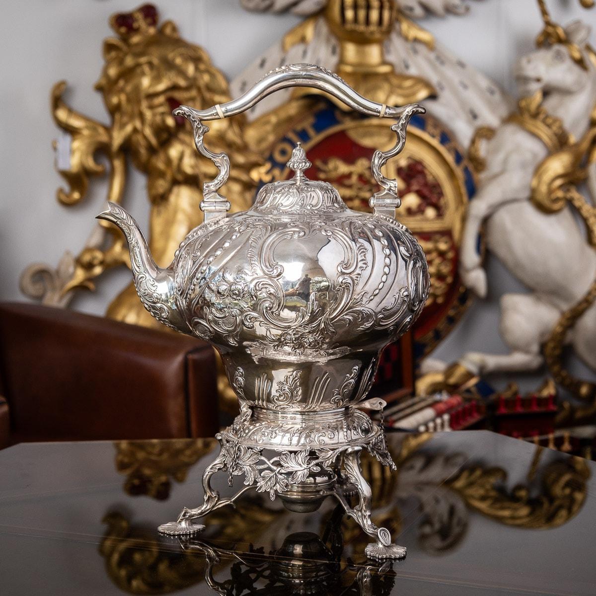 Antique mid-19th century Victorian solid silver tea kettle on a three feet burner stand, impressively large and very heavy (twice the size as a usual one), the swirl fluted body is chased with scrolls, beads and flowers, the domed hinged cover