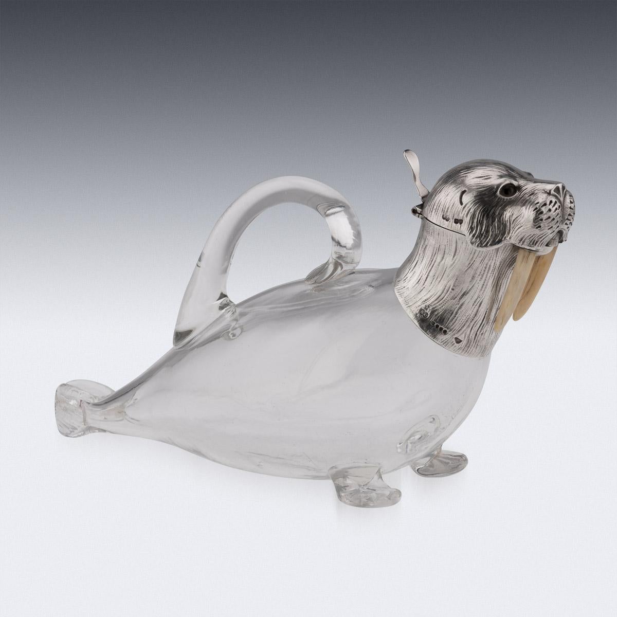 19th Century Victorian silver & glass novelty wine jug, the glass body and silver head beautifully imitating a walrus, the head made in two section with a hinged lid, a thumb-piece and mounted with glass eyes. Hallmarked English Silver (925