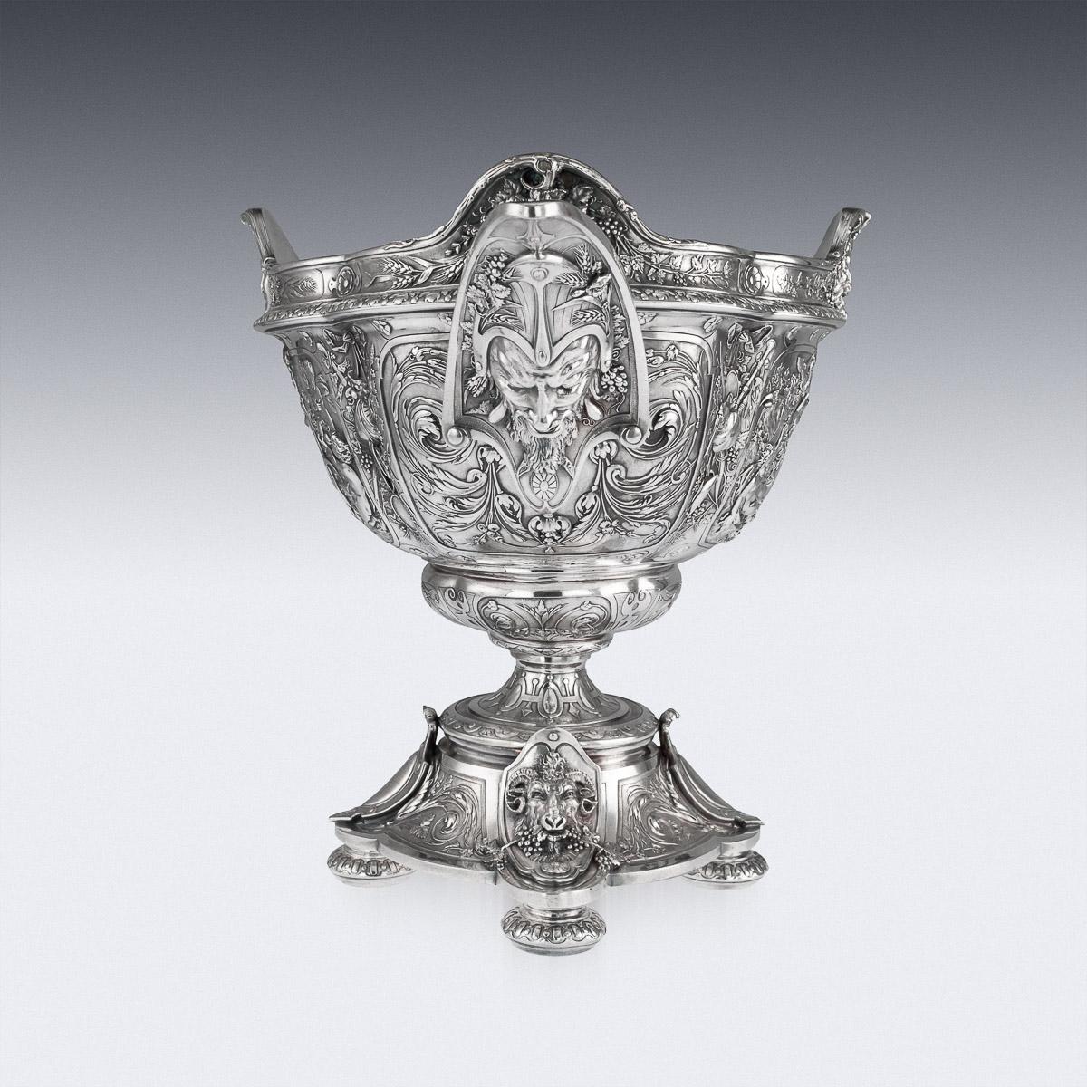 Antique late 19th century exceptional Victorian silver plated centerpiece bowl, of oval form on a lobed oval base on four circular feet, applied with satyr masks and shields, the body with panels of classical goddesses reclining amid grapes and