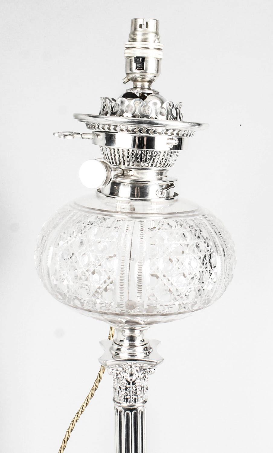 This is an elegant antique Victorian silver plated Corinthian column table oil lamp base converted to electricity, circa 1890 in date.

The lamp features its original glass mounted facetted cut clear glass oil reservoir and fittings, a capital