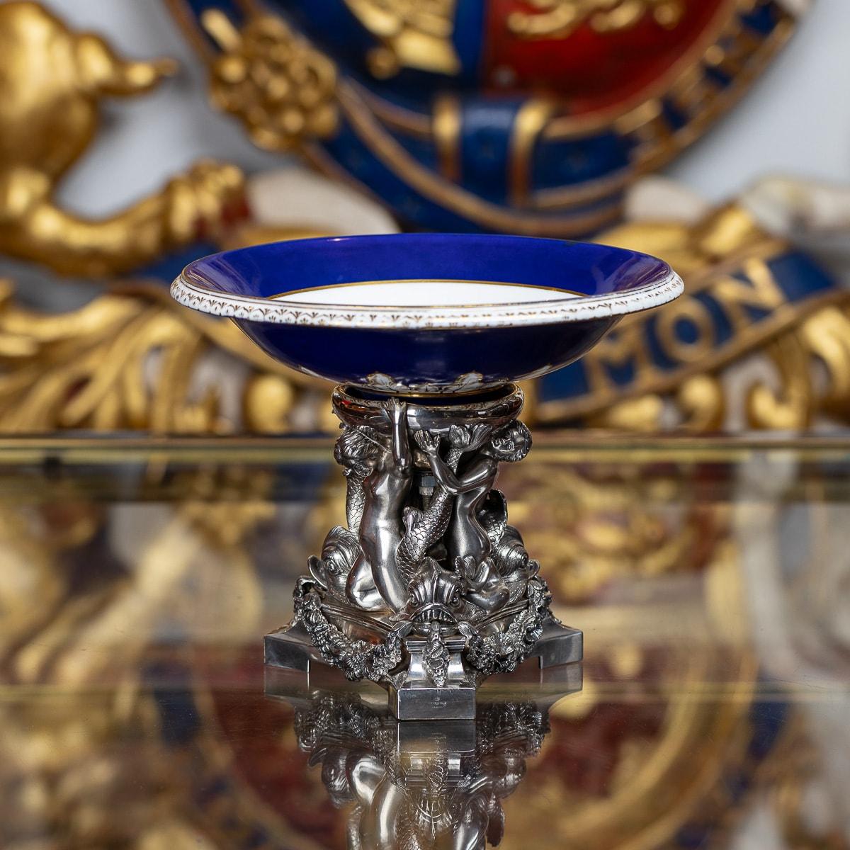 Antique mid-19th Century Victorian solid silver figural centerpiece, raised on trefoil shaped base, the base is applied with cast swags decorated with oceanic crustaceans, supporting three finely modelled mermaid figures and dolphins, suspending a