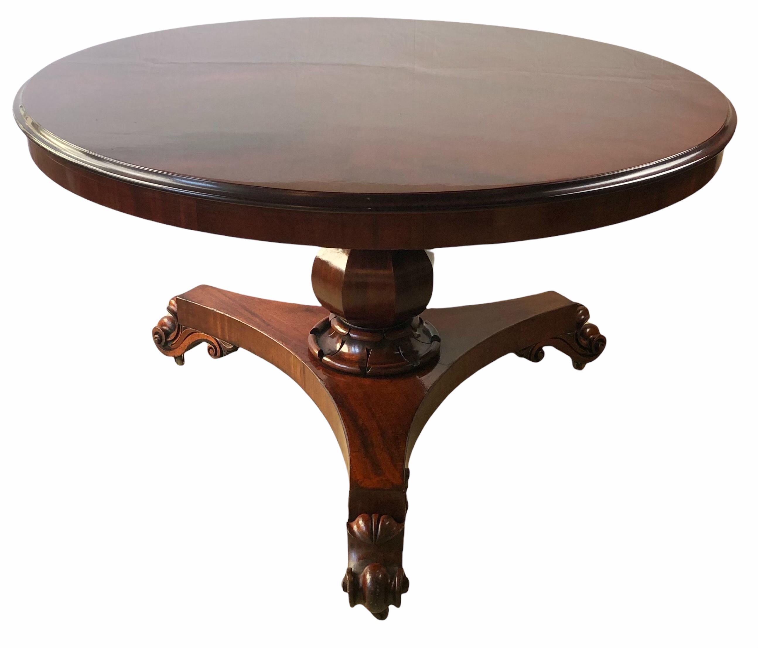 A stunning 19th century Victorian Tilt-Top Center Table or Dining Table. Constructed of solid Cuban mahogany. 

An exceptional round tilt-top table with rich solid mahogany of spectacular butterfly or open book cut. This is not a table with veneer,