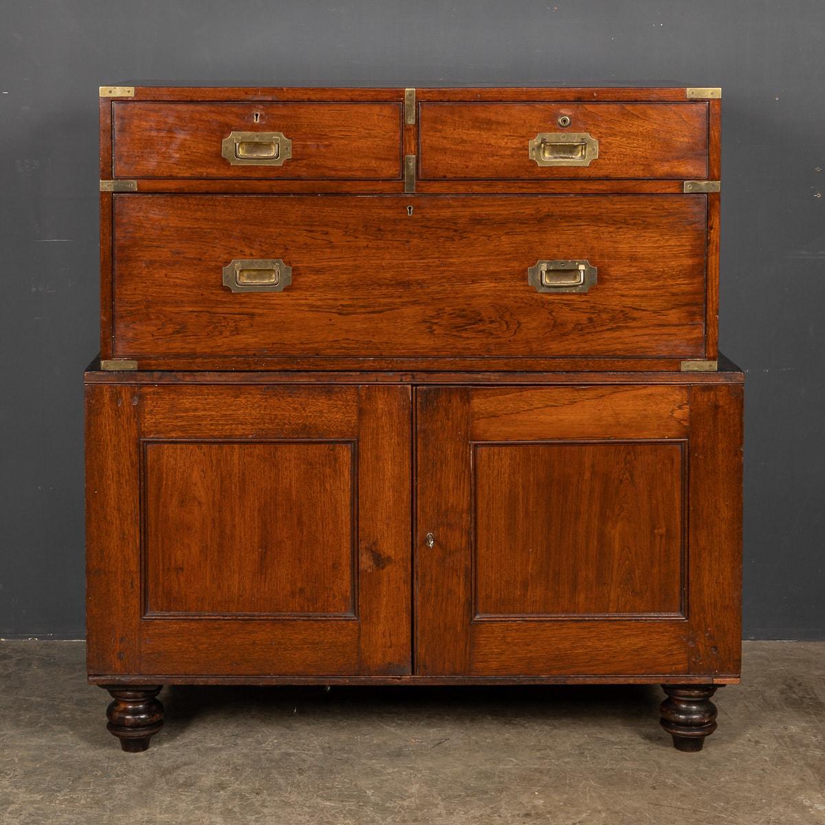 Antique 19th Century Victorian rare piece of campaign furniture, crafted in mahogany. In two pieces the top set of three drawers fitting snugly inside the lower cupboard for traveling. This piece has original brass campaign handles, lock and key