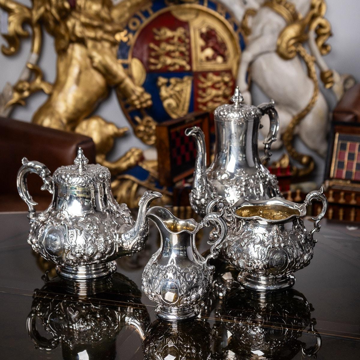 19th Century Victorian silver four piece tea & coffee service, comprising of a coffee pot, tea pot, sugar bowl and cream jug, each shaped body resting on a spreading domed base, the body chased and embossed with intertwining scrolls, roses and
