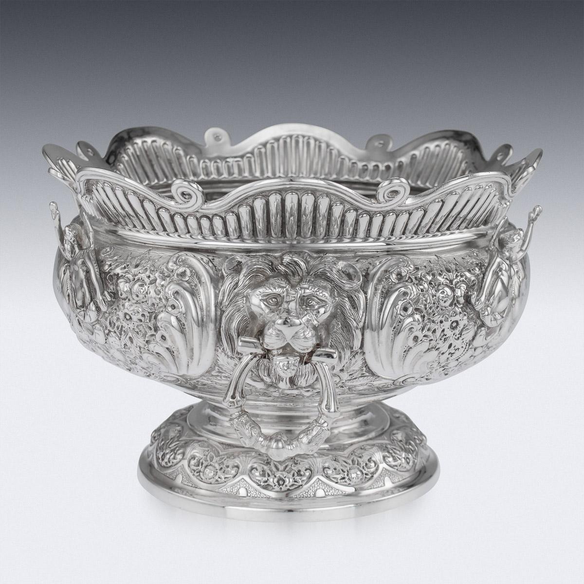 Antique late-19th century Victorian solid silver Armada bowl, the body is profusely chased and embossed with a crisp floral decoration, each side features cast applied projecting angels to either side of a vacant cartouche, applied with lion's masks