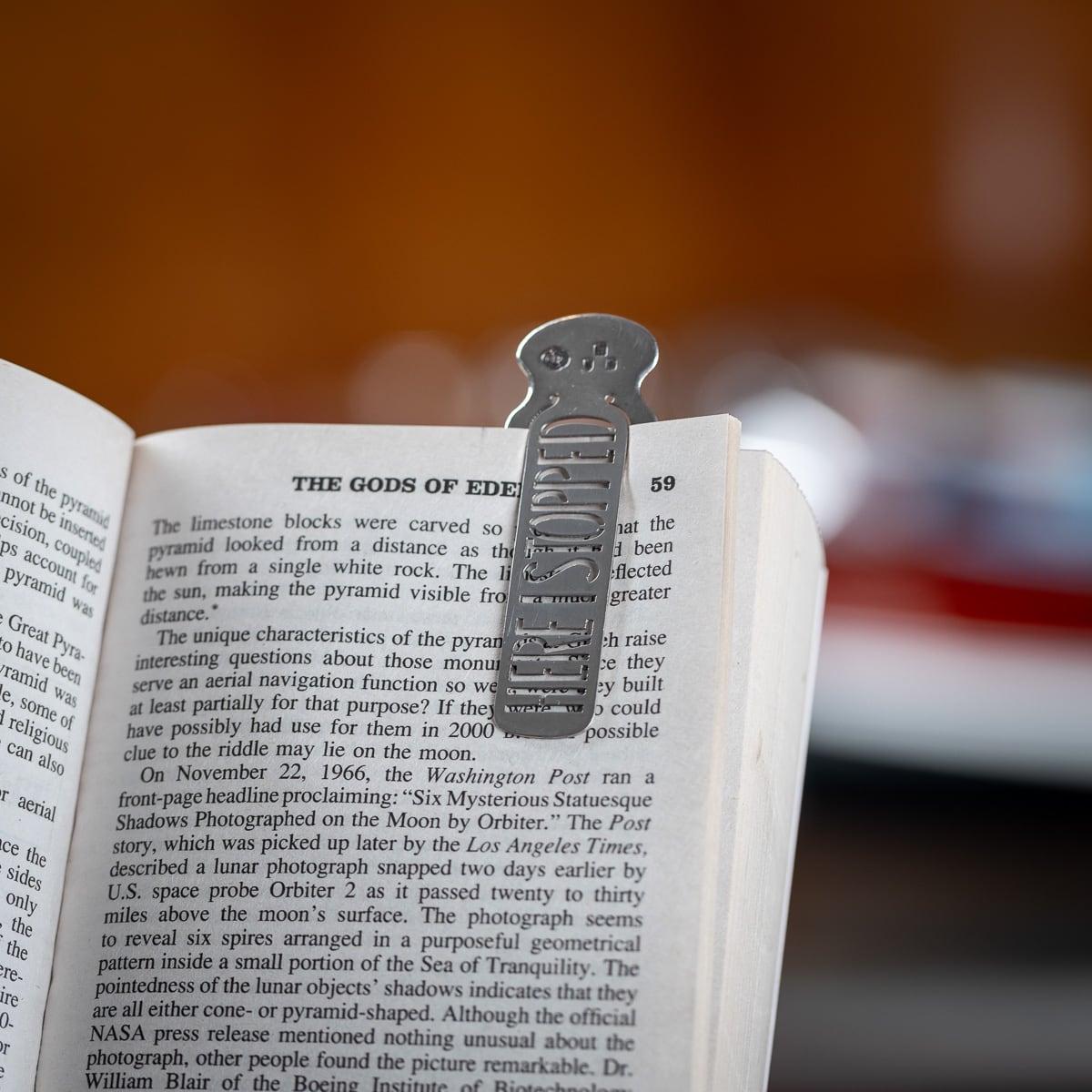 Antique late 19th Century Victorian solid silver bookmark. The bookmark is in the shape of a bottle, with an unusual cut out section within that says 