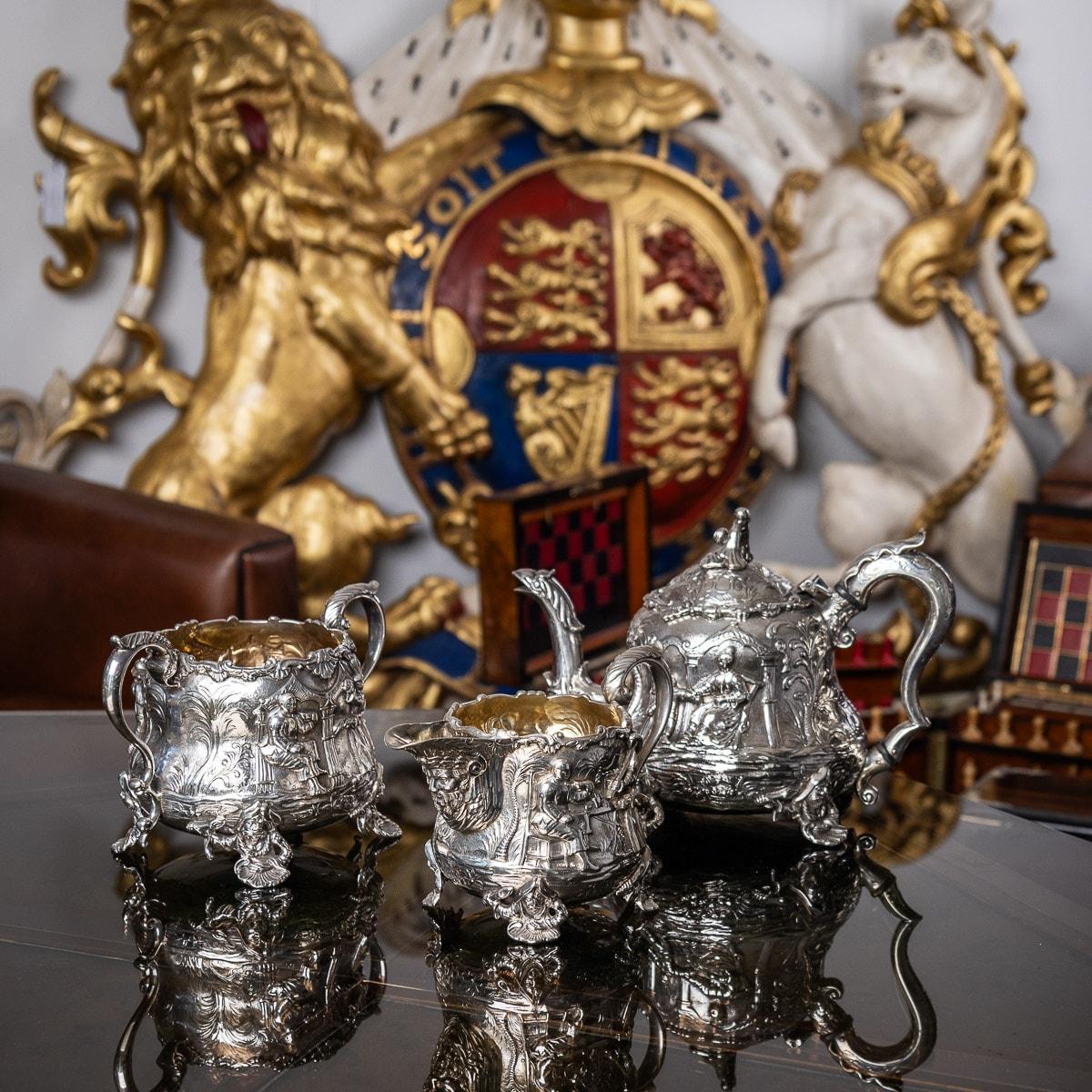19th Century Victorian silver Chinoiserie style three piece tea set, very heavy and decorative, each pear-shaped body embossed and applied with various oriental scenes, the stylised leave capped C shaped handles are beautifully modelled and the