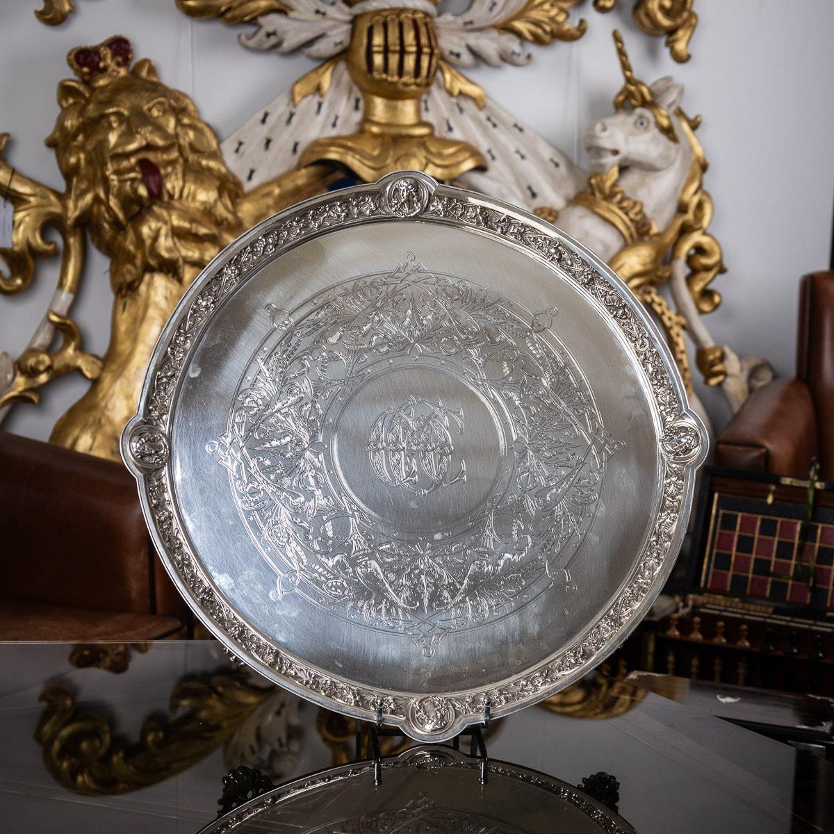 Antique 19th century Victorian solid silver salver with an unusual neoclassical border, impressively large size and extremely heavy gauge, of shaped-circular form on four impressive cast scroll feet, with applied cast border decorated with Italian