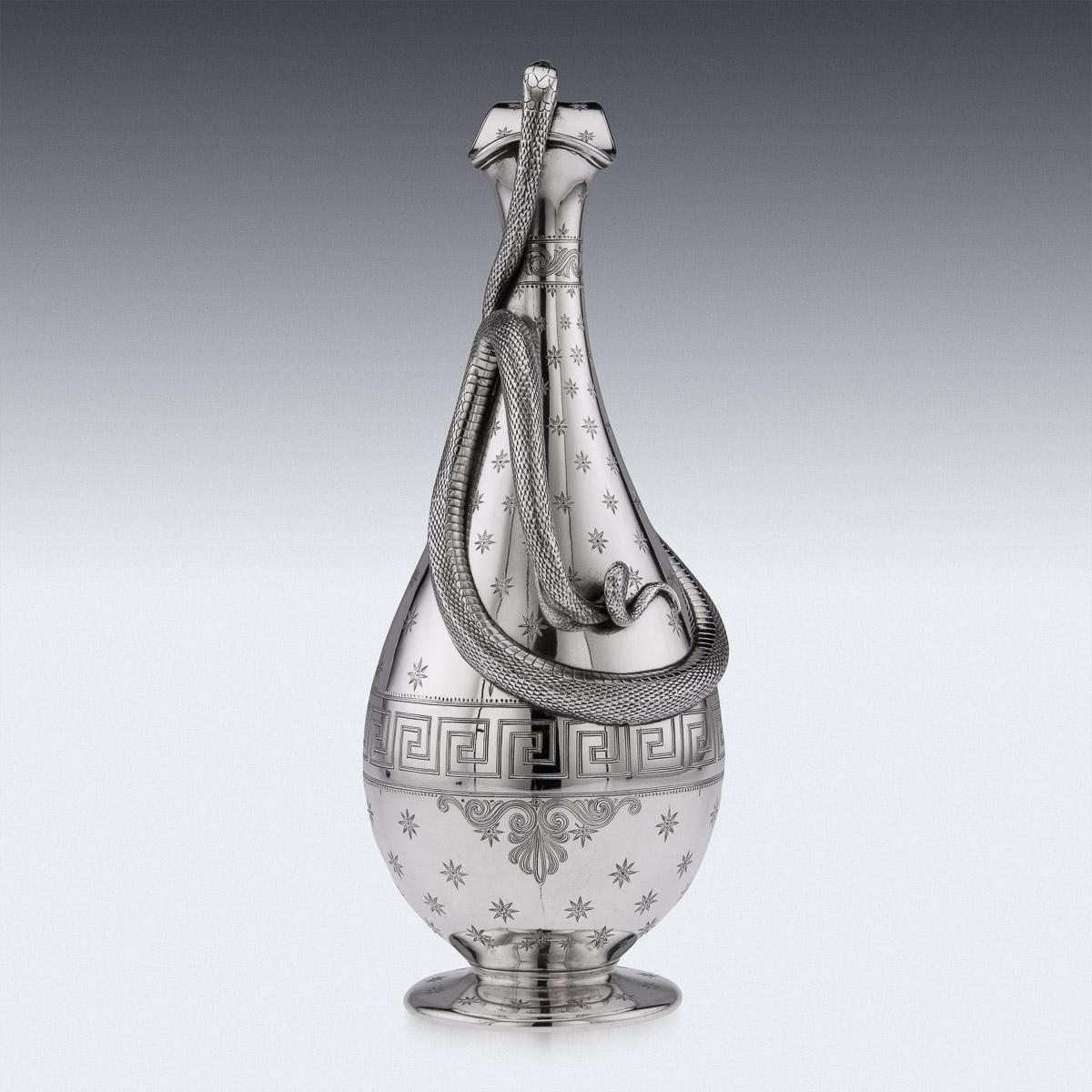 19th Century Victorian silver magnificent wine jug, of very large size, baluster form, the body engraved with Grecian turn key border, with a large oval vacant cartooche surrounded by star bursts and the body applied with a realistically modeled