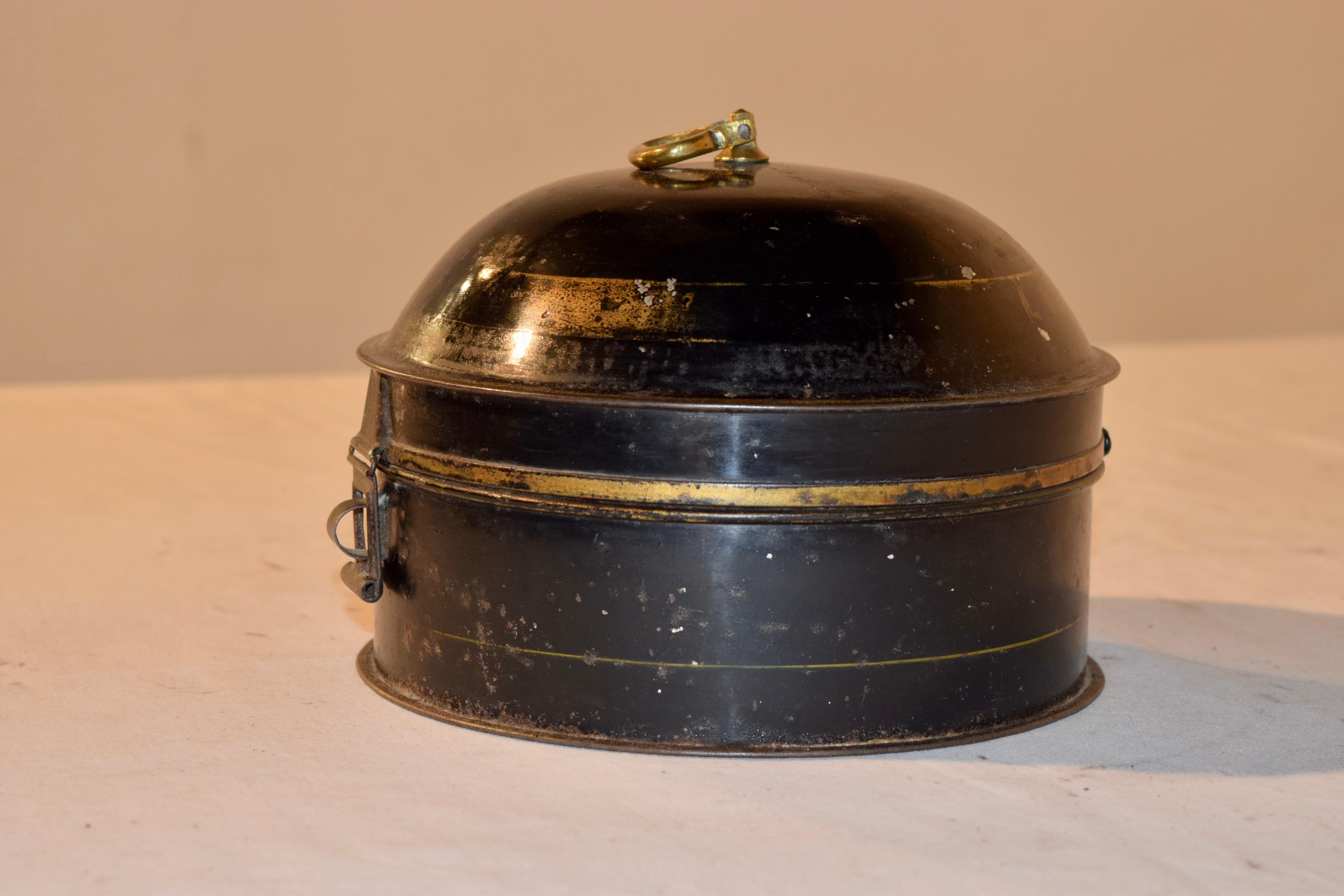Lovely original antique spice container, internally divided into six compartments. It is a lovely looking tin with a domed top and small brass handle on the top. There is a catch at the front to hold it closed. It is painted black and there are