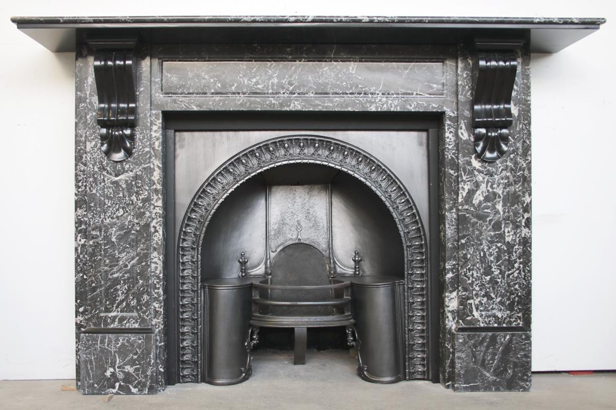 Large 19th century Victorian St Anne marble fireplace surround with carved corbels in Belgian black marble supporting the shelf.  Circa 1880. Removed from an end of terrace property in Manchester, England.

Pictured with an original Victorian cast