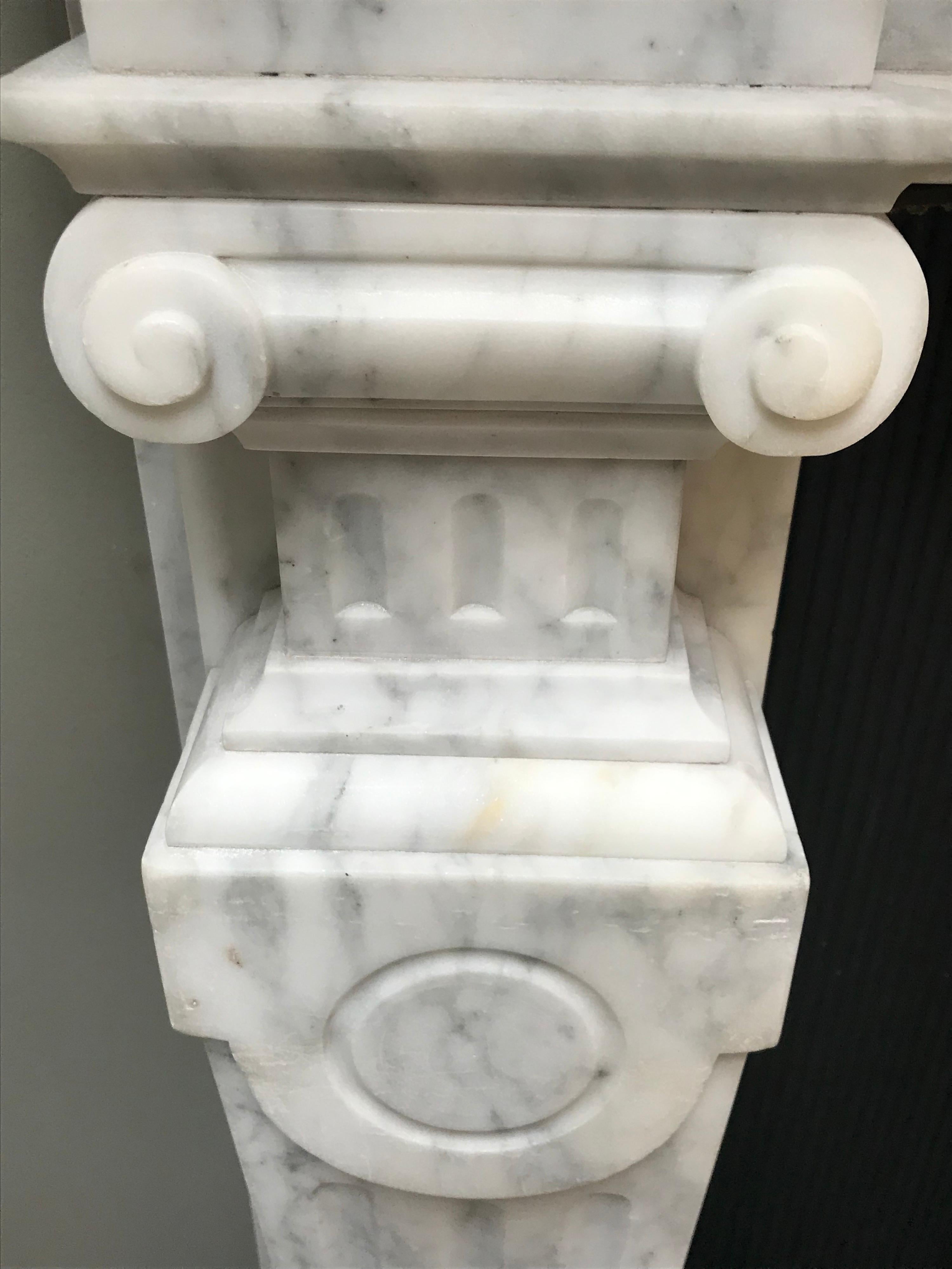 19th century fine English Victorian statuary honed marble fireplace surround.
Hand carved with fluted pilasters tapered jambs. With fine ornamental tablets
On recessed paneling above the capitals and its centre block.
This true glorious bold example