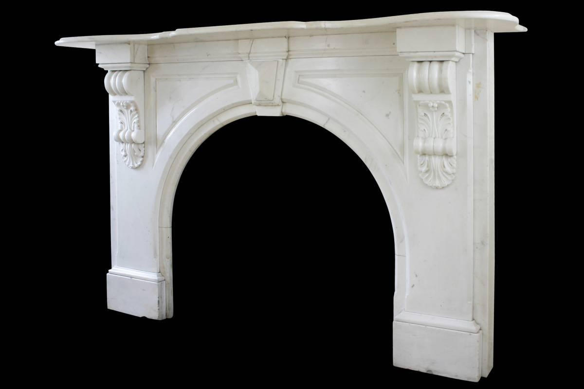 Large Victorian statuary white marble fireplace surround with and arched aperture and heavily carved corbels supporting the serpentine shelf. Images prior to restoration. When this fireplace is purchased it will then be fully restored. The price