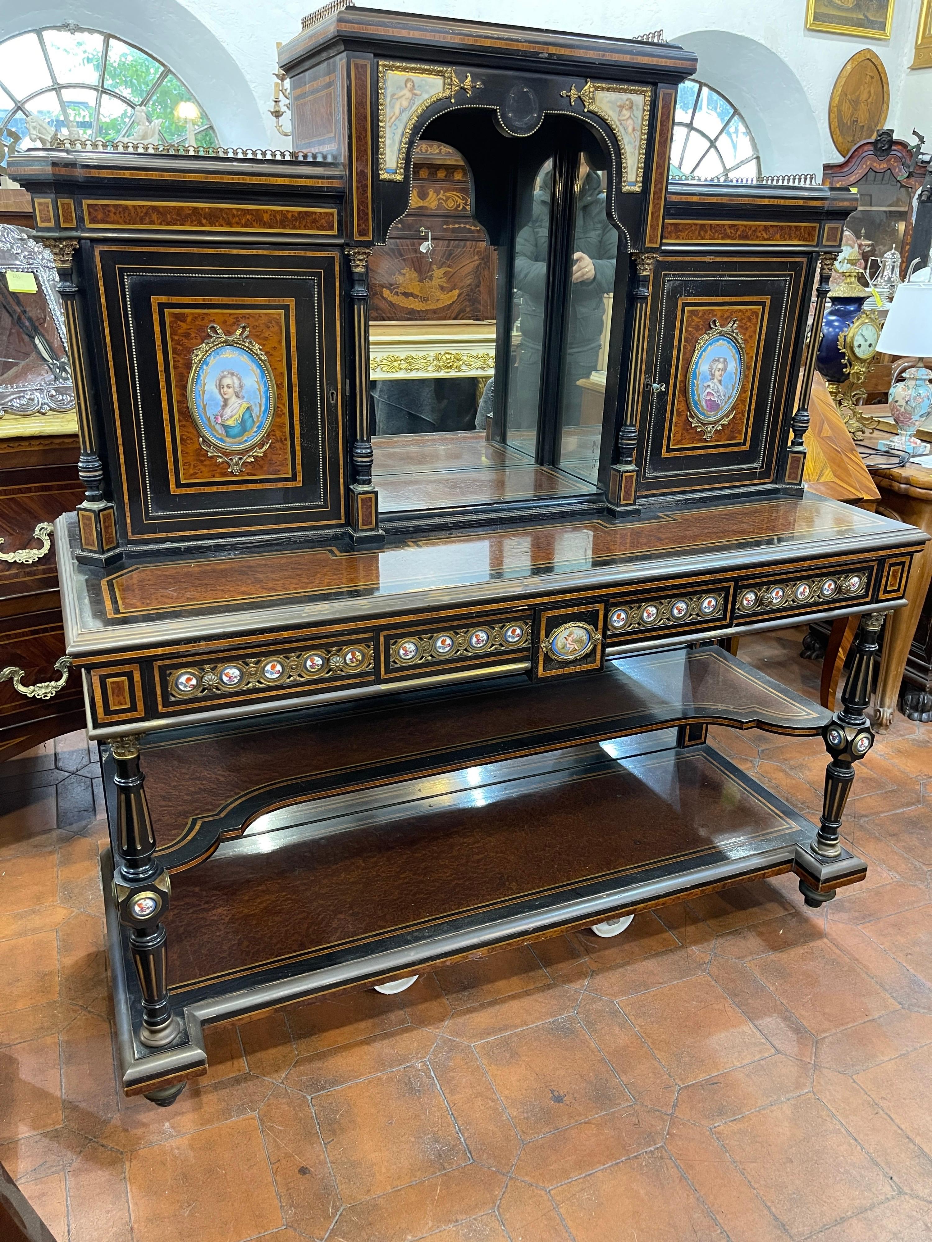 Antique Victorian Bonheur Du Jour, imposing piece of furniture from the Victorian era.
 In Amboyna and Thuya wood, with hand painted Sevres porcelain plaques. 
A porcelain plate is missing from the top. The cabinet once chosen will be carefully