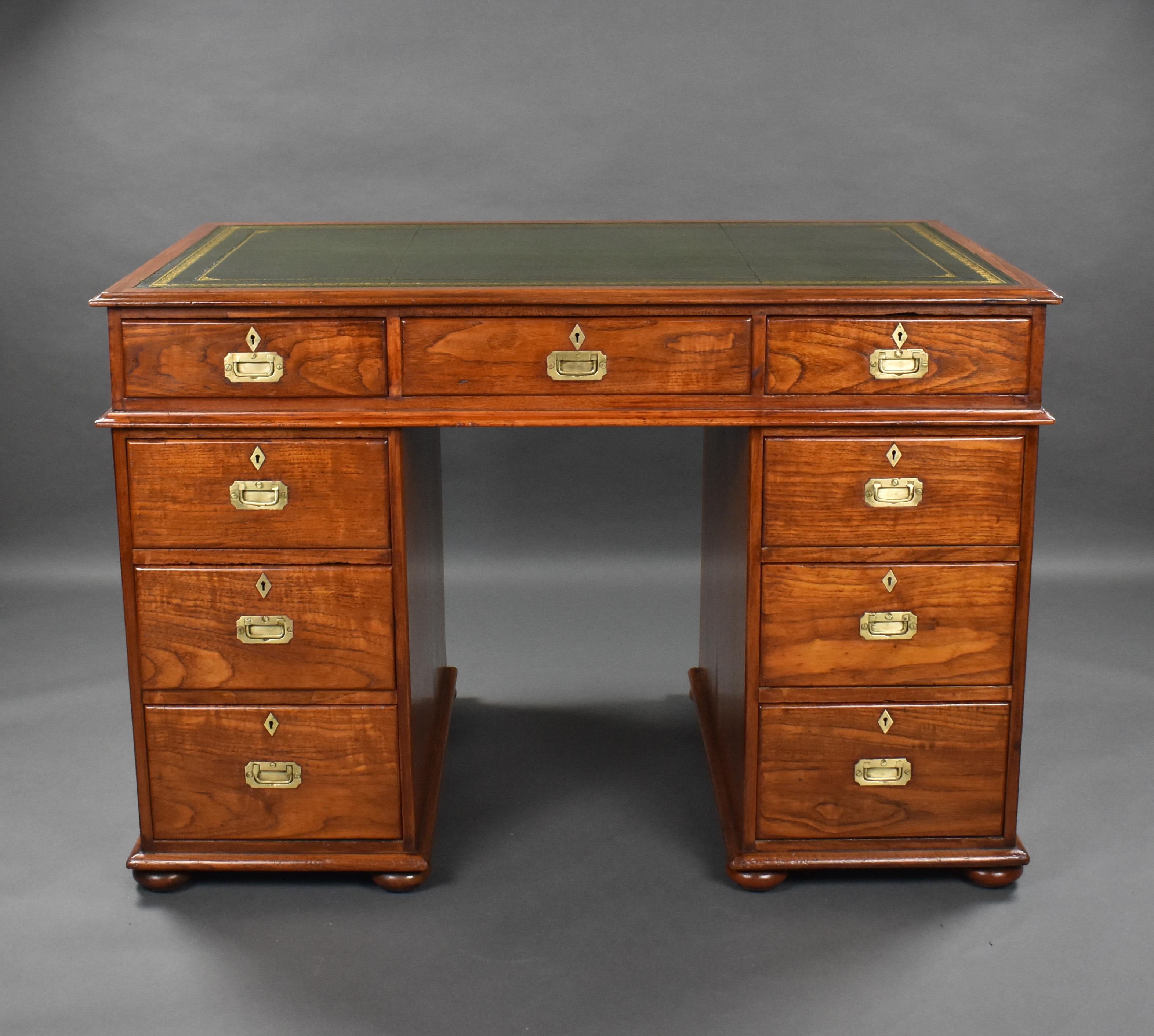 For sale is a good quality Victorian teak campaign style desk, the top having a green leather skiver, decorated with gold tooling above three drawers each with inset brass handles and escutcheons. The top fits onto two pedestals, each with an