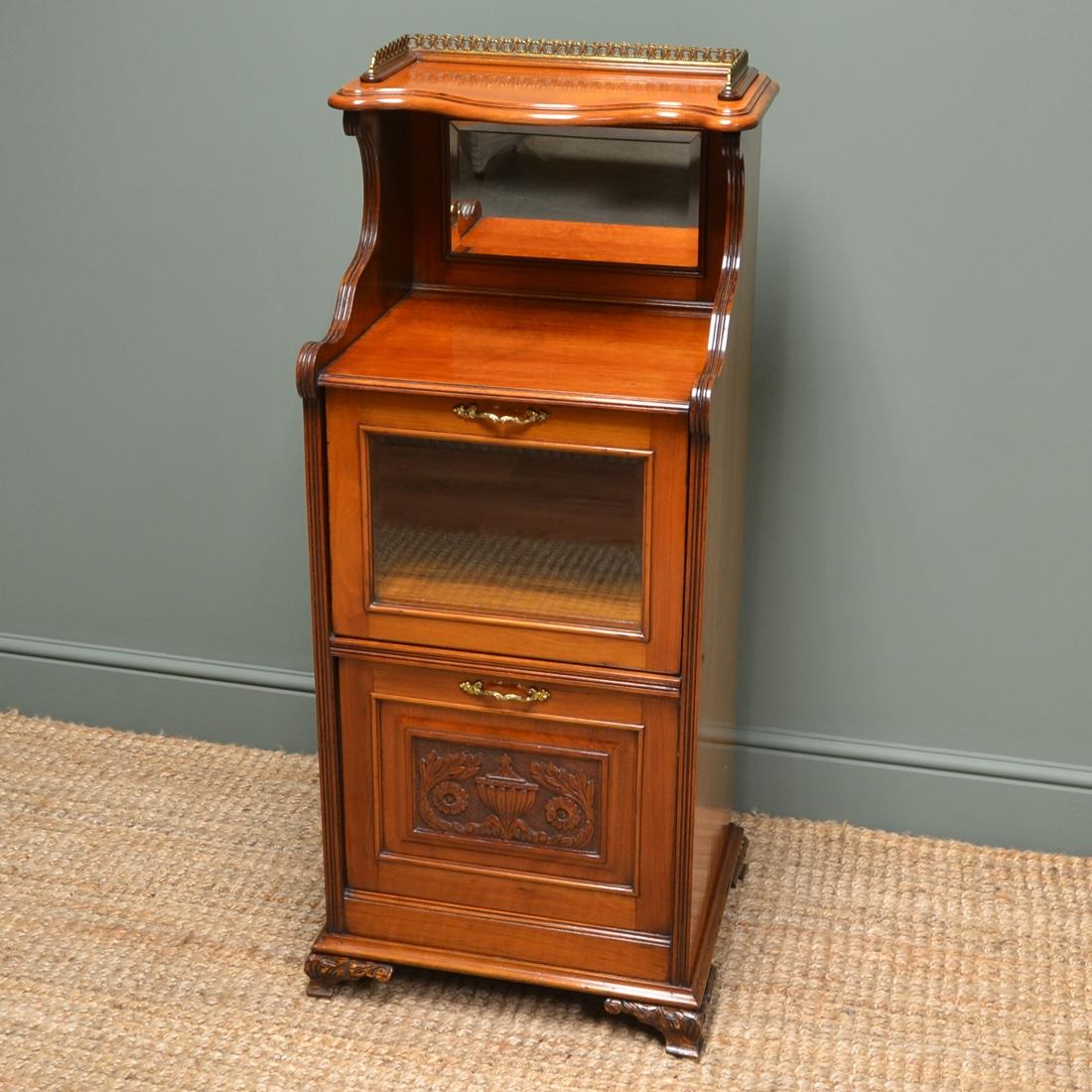 Victorian walnut antique side cabinet
This beautiful late 19th century Victorian walnut antique side Music cabinet dates from ca. 1890 and has a shaped moulded top with brass gallery above shaped sides, the original bevelled mirrored back, a glazed