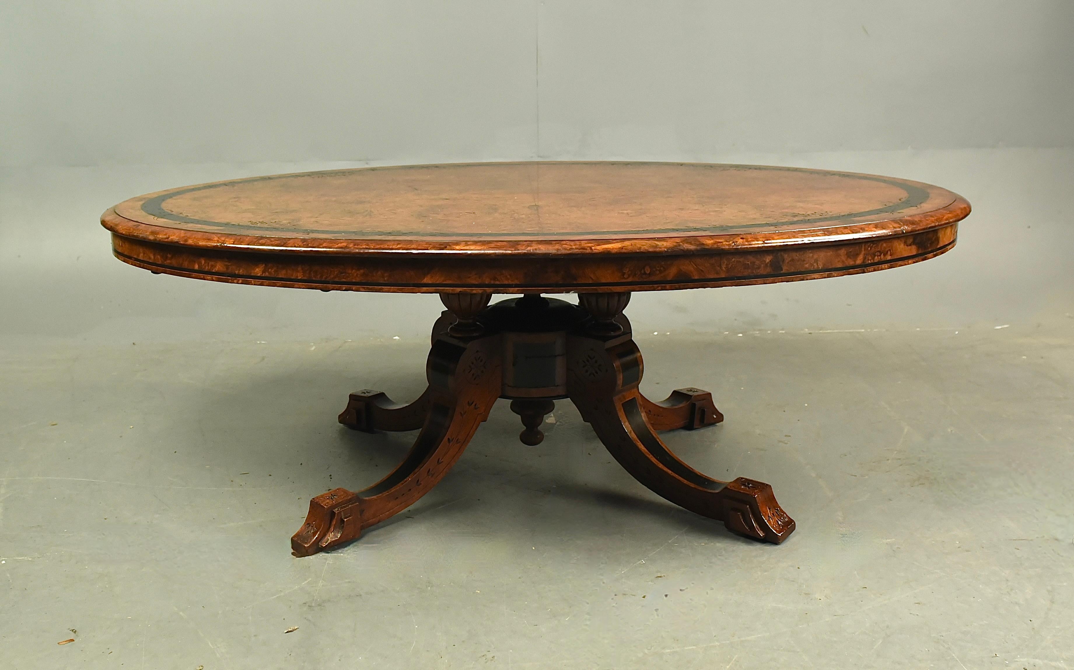 Fine Victorian oval burr walnut coffee table .
The coffee table is a great colour with good figuring with fine Quarter veneered burr walnut with ebony banding and fine  floral carved details .
The base has four out swept legs with ebony inlay and