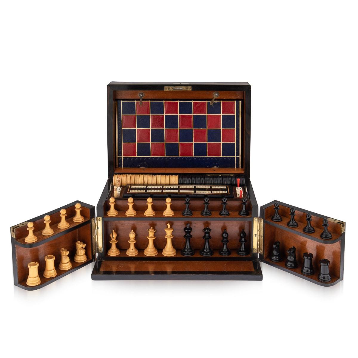 Antique late-19th century Victorian walnut cased games compendium, the interior comprising a chess set, draughts, dominoes, dice, cribbage board with markers, leather bound boards for games, playing cards, droughts counters, a dice shaker. A superb