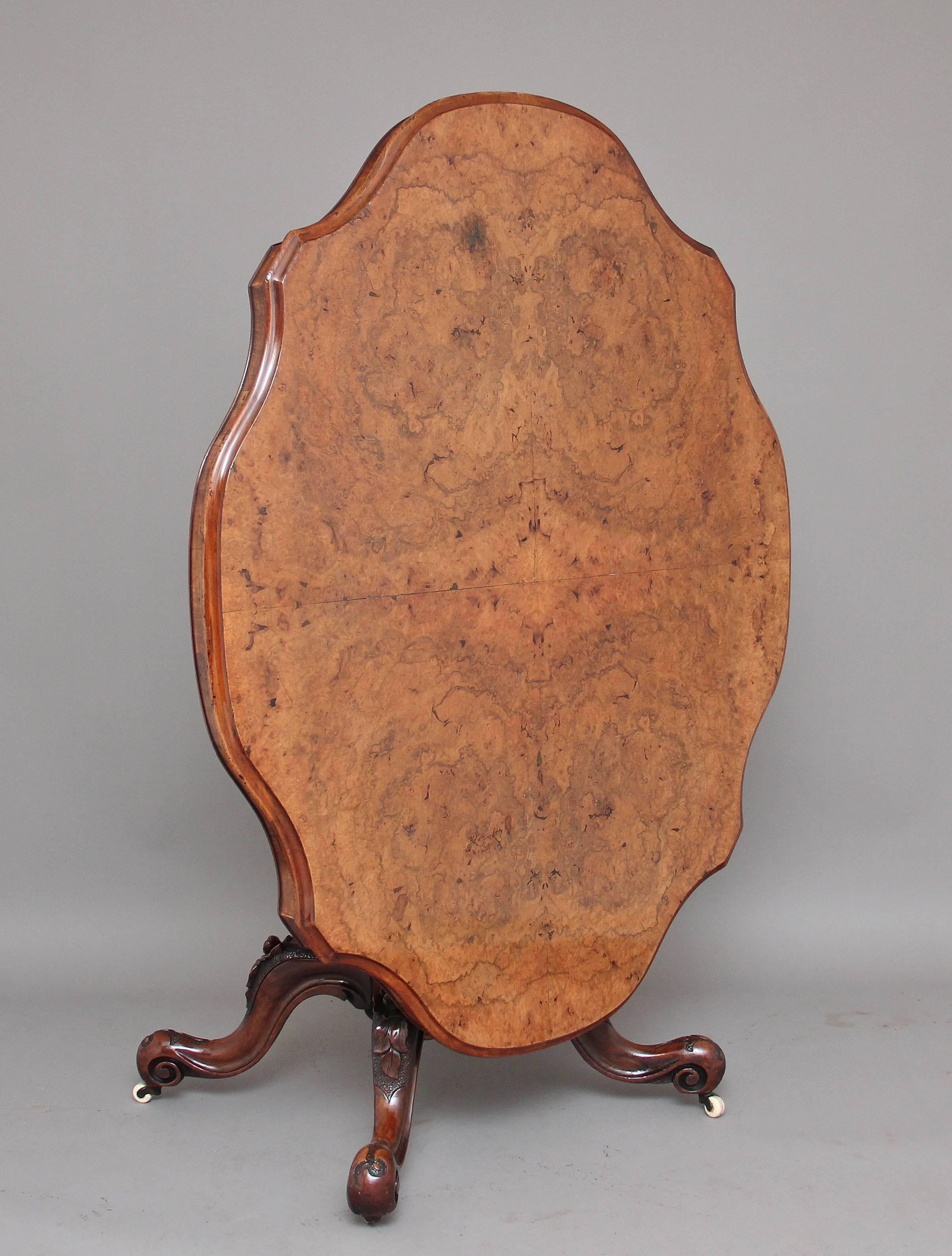 19th century Victorian walnut loo / breakfast table, the shaped four quarter veneered oval tilt top having a moulded edge and nice shaped frieze, supported on a bold column with four stamped and carved cabriole legs, lovely carved floral decoration