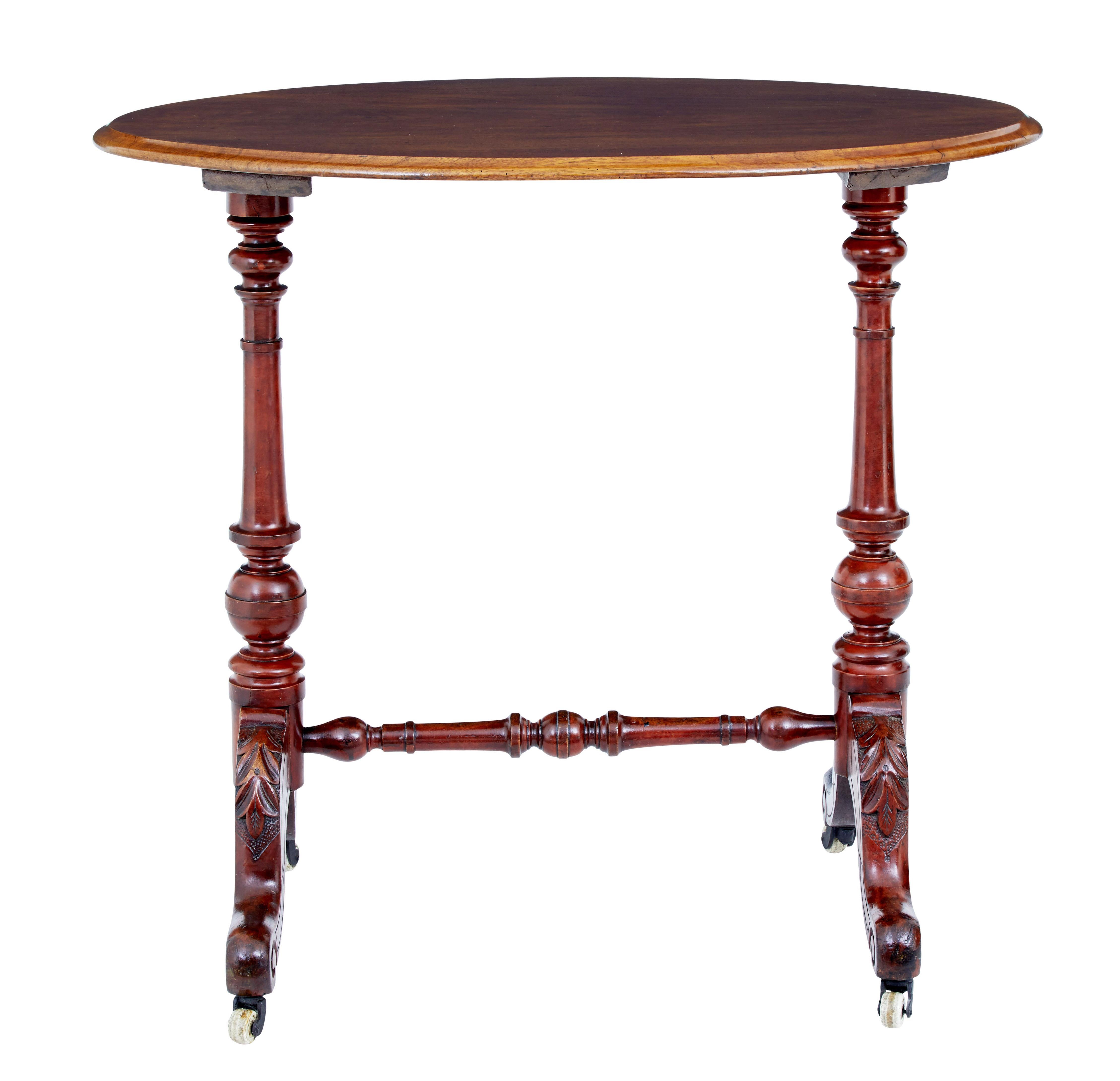 Functional piece of Victorian furniture circa 1870.

Oval walnut top, on a typical Victorian turned base with scrolling feet and carved acanthus leaf detail.  Standing on ceramic castors.

Base with evidence of being stained.  Minor surface