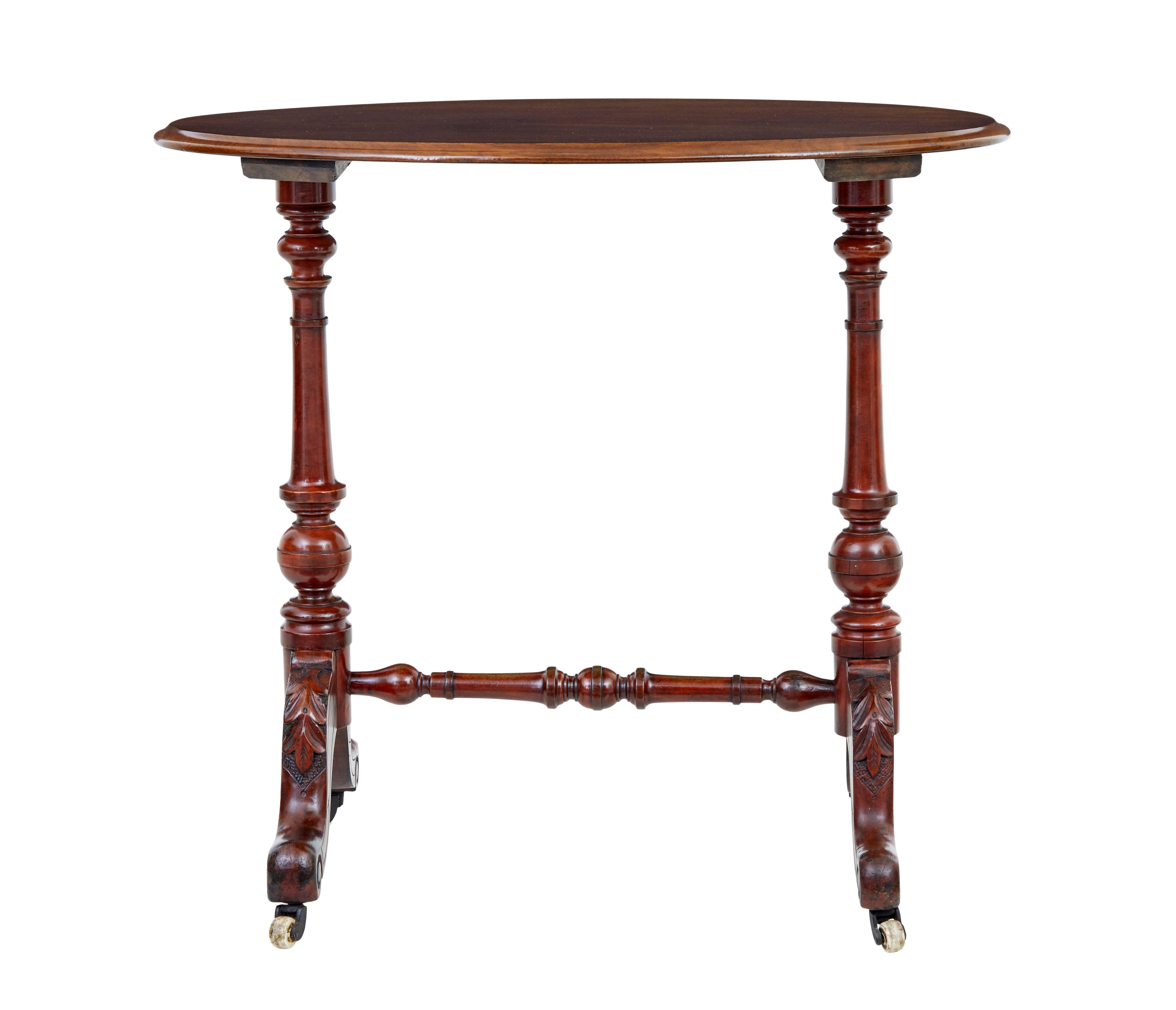 Functional piece of Victorian furniture circa 1870.

Oval walnut top, on a typical Victorian turned base with scrolling feet and carved acanthus leaf detail.  Standing on ceramic castors.

Ideal for use as a side or lamp table.

Base with evidence