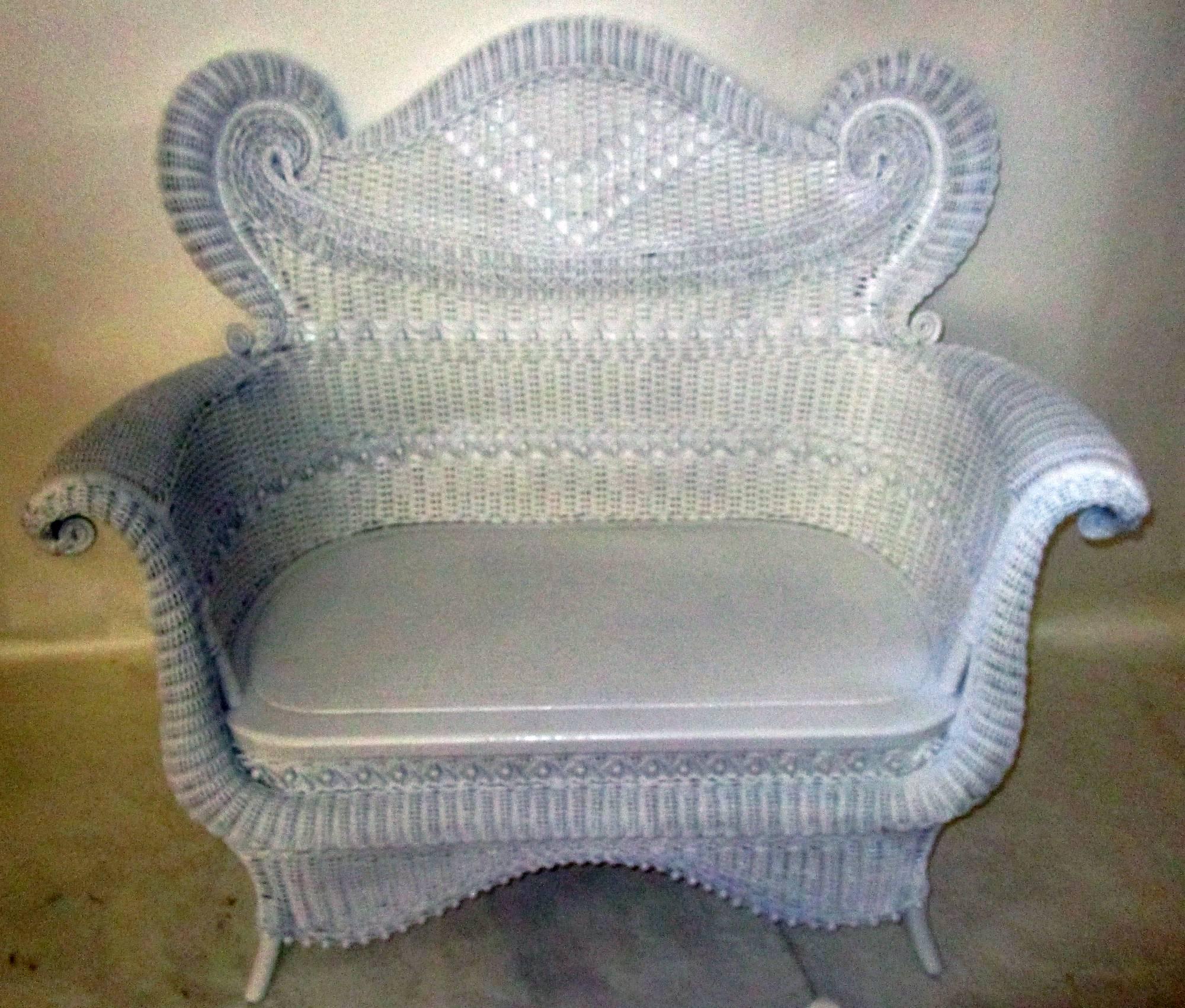 This painted wicker fanciful Victorian settee features all the bells and whistles the Heywood Bros. and Wakefield Co. was known for; curves, rolls, curlicues, scrolls, fish scales and tiny wooden beads. On a very sturdy hard wood (ash) frame with a