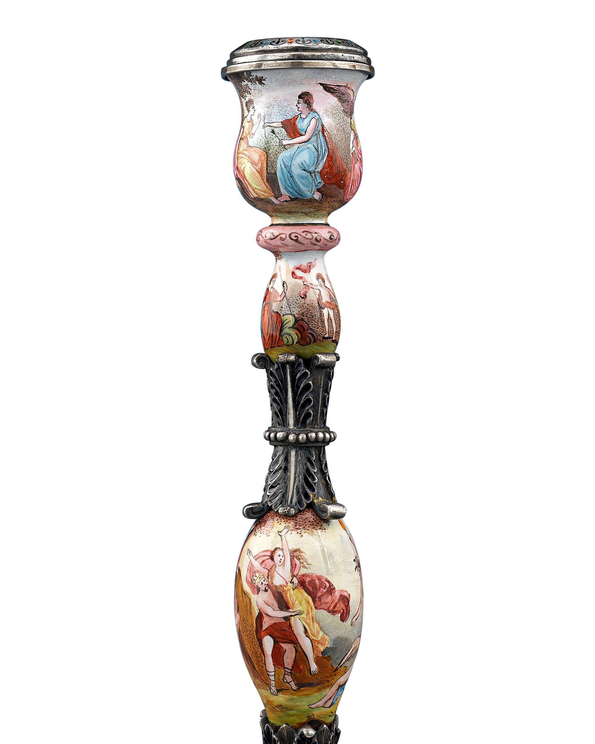 Splendid continuous hand-painted scenes adorn these graceful and rare Viennese silver and enamel candlesticks. Adorned with scenes of gods and goddesses from classical mythology, these lights are executed with exceptional detail and artistry. A