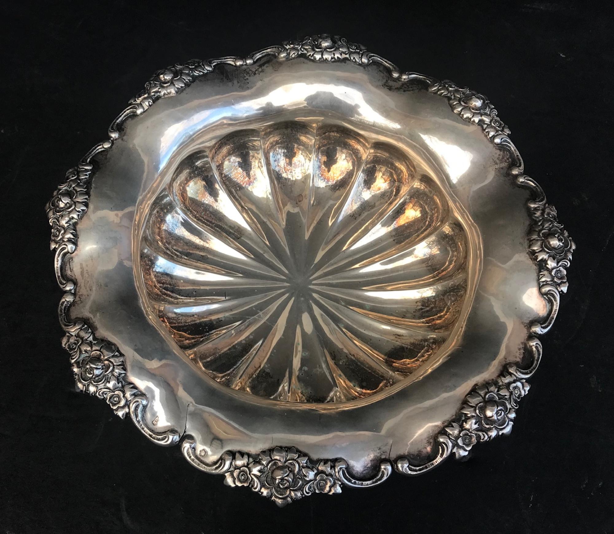 Viennese heavy silver Victorian footed bowl scalloped and embossed, circa 1870

A round, scalloped, flared rim dish boasts an ornately embossed floral design. The heavy body features a bulbous radiating panel design raised on four claw feet. The