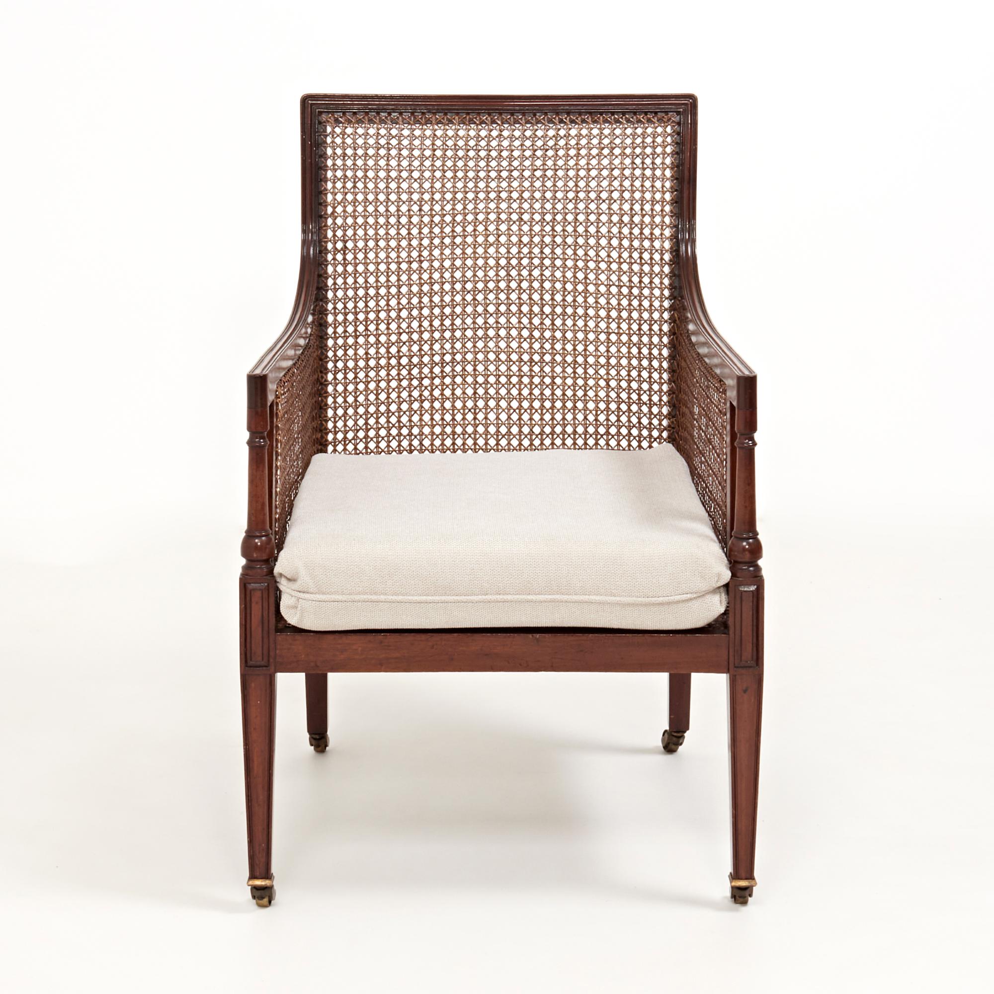 A stunning bergère mahogany Gentleman’s library chair.

Featuring the original caning on the backrests and arms with the seat cushions newly reupholstered in soft grey fabric for the ultimate comfort.

The legs of the chair feature unique