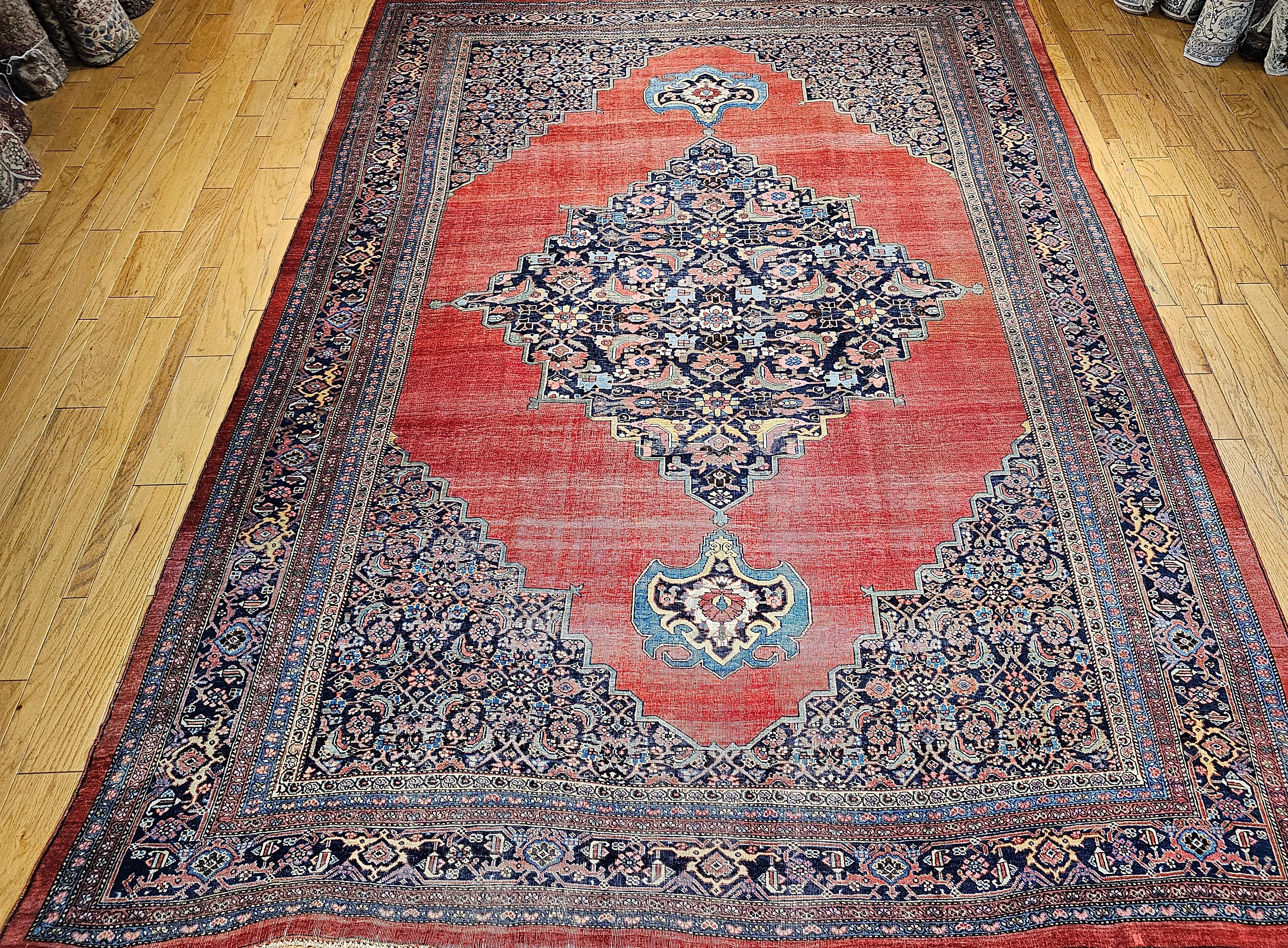 The oversized Bidjar (Bijar) rug is a unique and extremely desirable open field design in an abrash red color.  The design of the corner spandrels is Herati with accent colors in French blue, pink, cream, brown, cream, and yellow.  There is a
