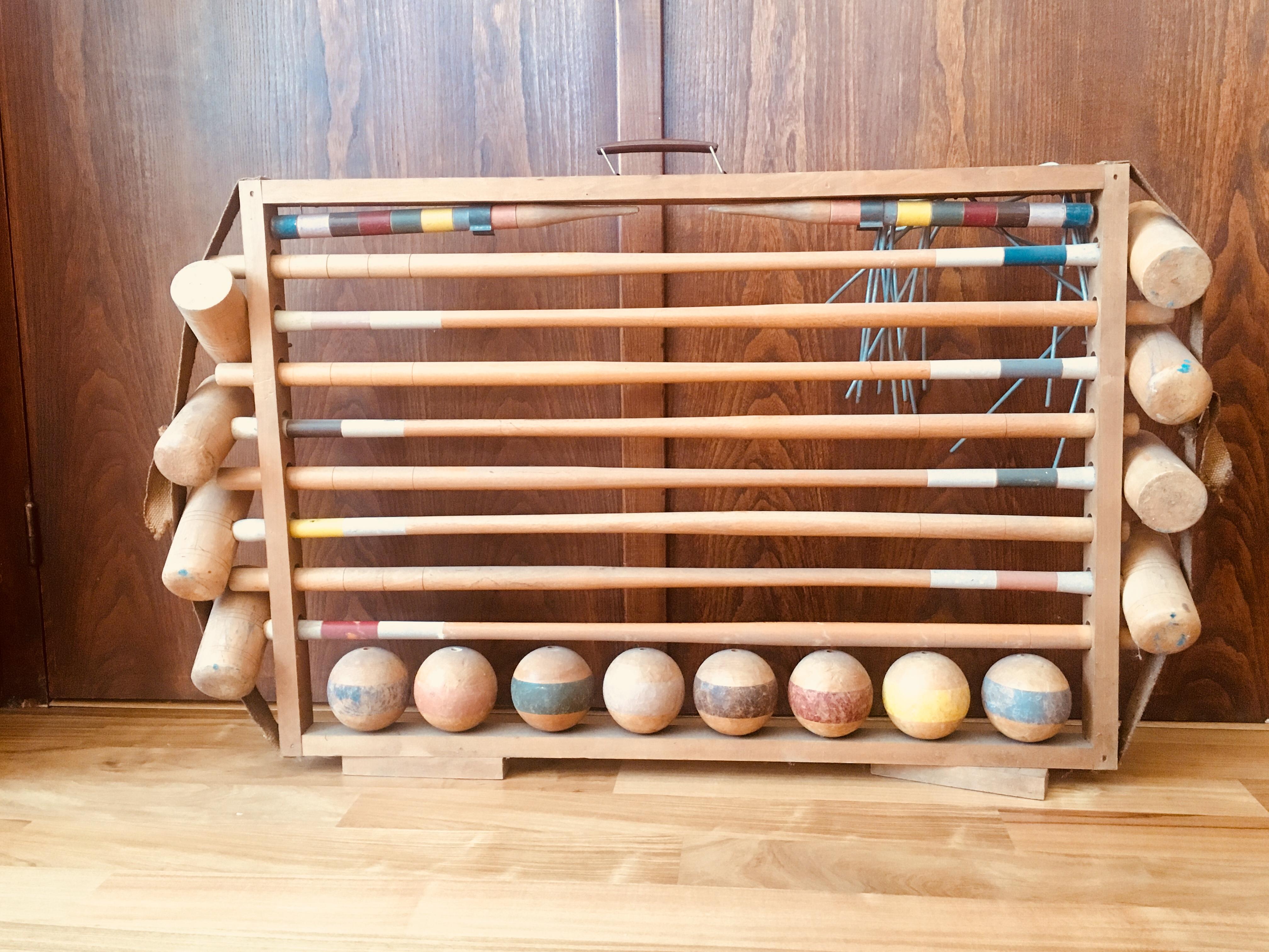 Dating to the late 19th century, this wonderful French croquet set with worn and original painted stripes is hand-carved from oak and is placed in its original wooden case.
France, circa 1890.