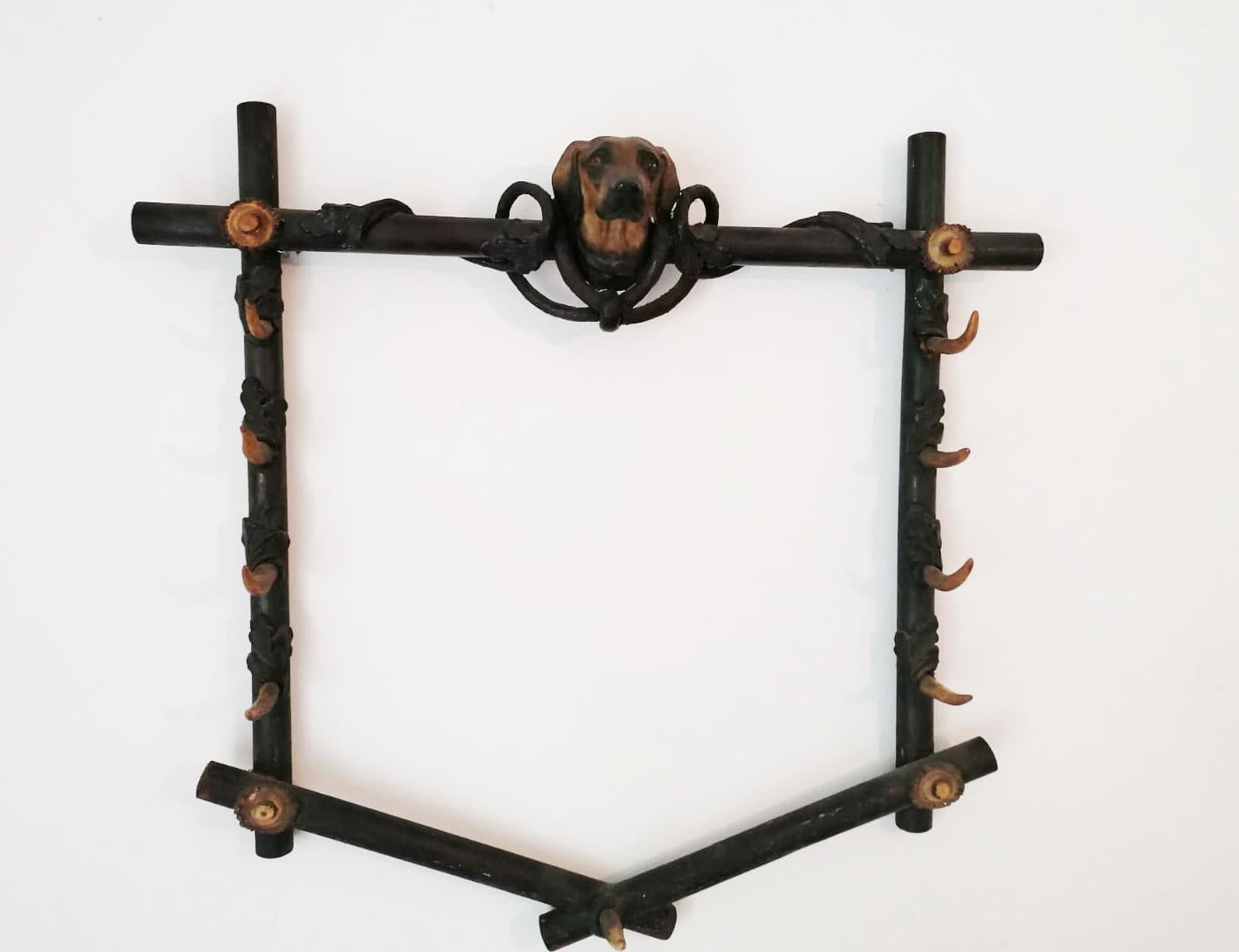 Walnut wood frame with antler part as holder fixed with bone glue, dog head made of wood and a mix of wood chips and bone glue painted, glass eyes. Made in Austria in the 1860s
(The walking stick is just for demonstration of the function and belong