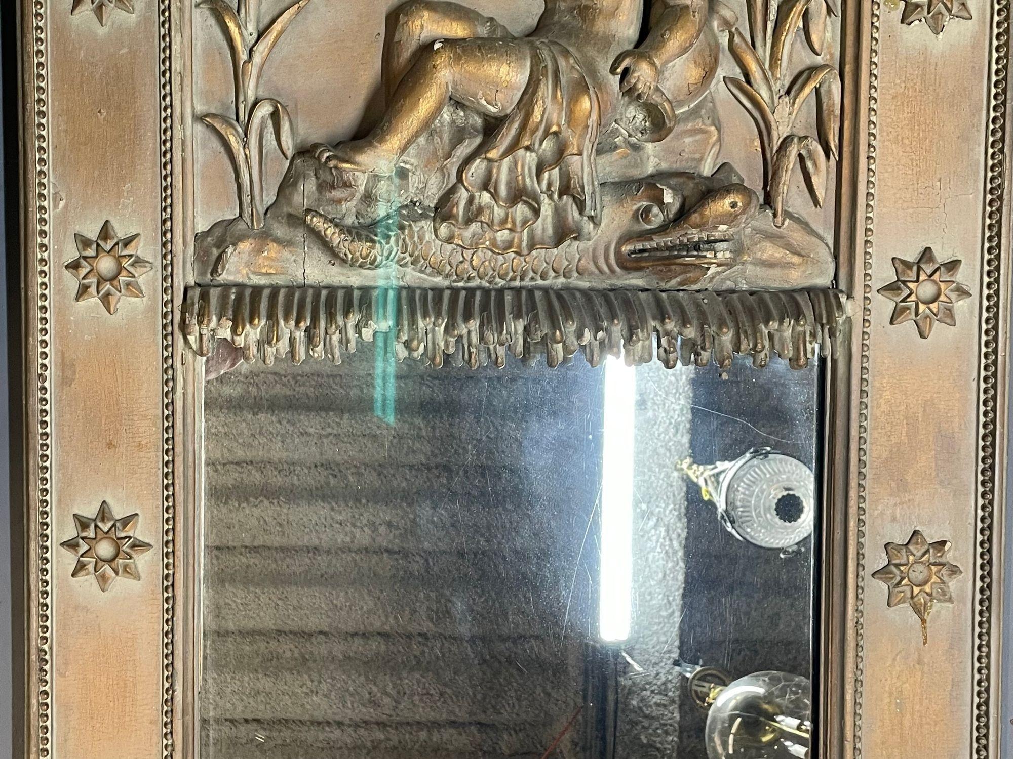 19th century wall, console or Pier Cherub mirror
 
Wall or console mirror having a clear antique center panel flanked by a luminous gilt wood frame. Robust carvings of lion faces and stars support the trumeau style top that bears the mirror's