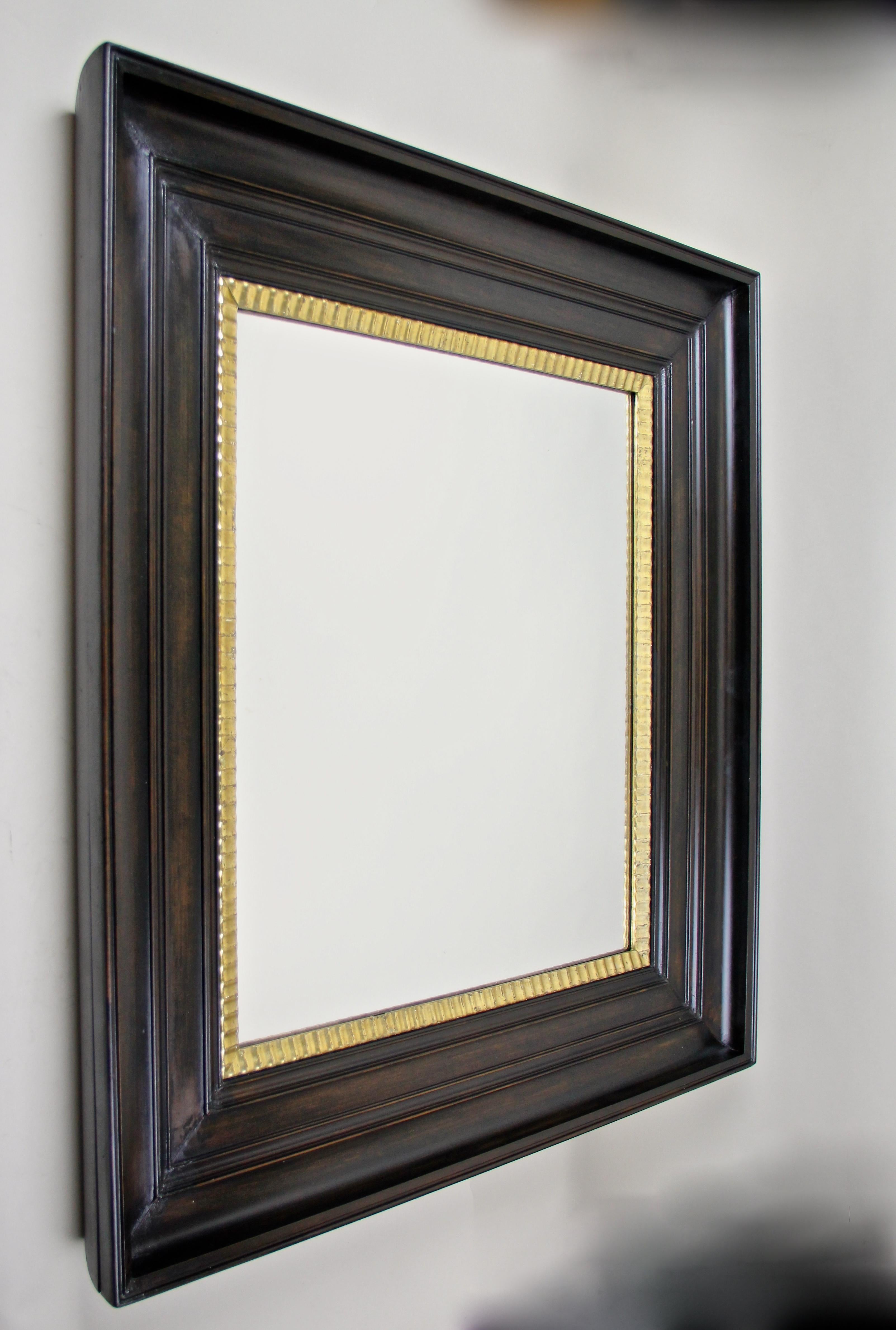 Timeless massive cherrywood wall mirror from the late 19th century circa 1890 in Austria. This beautiful large wall mirror impresses with its wide dark brown almost black stained, cambered cherrywood frame. So-called 