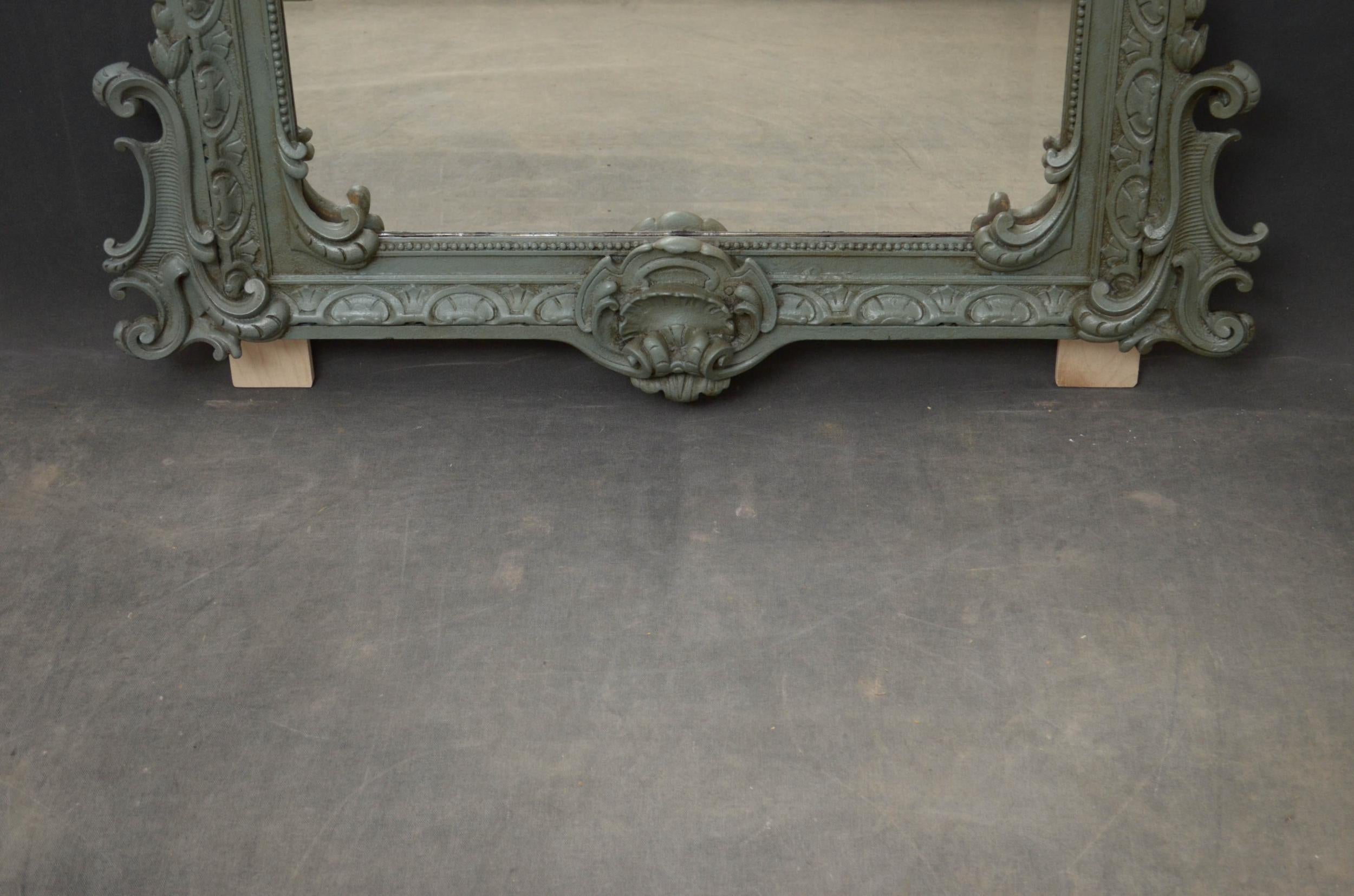 Sn4977 A 19th century Continental wall mirror, having original bevelled edge glass with some imperfections in finely carved painted frame with centre crest and scrolls to the top and base. This antique mirror retains its original glass and original