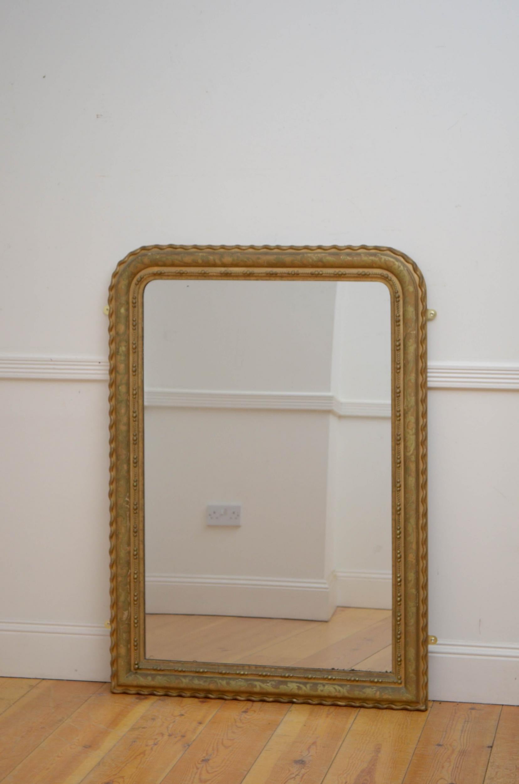 Sn5072 French gilded wall mirror, having original glass with some foxing in moulded frame with foliage decoration and wave border. This antique mirror retains its original glass, gilt with extensive patina and backboards, all in home ready