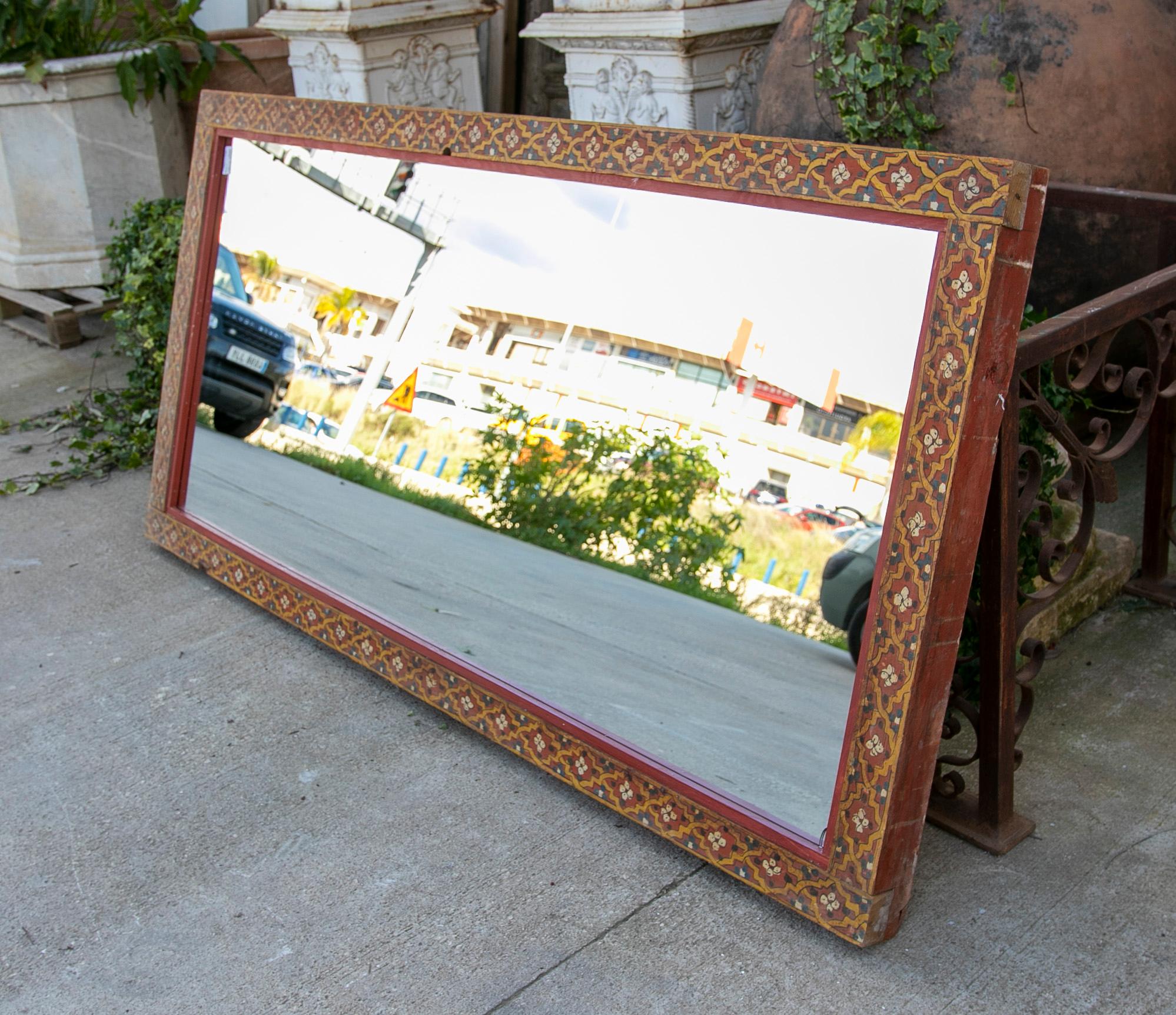 19th Century wall mirror with wooden frame made of polychrome panels.