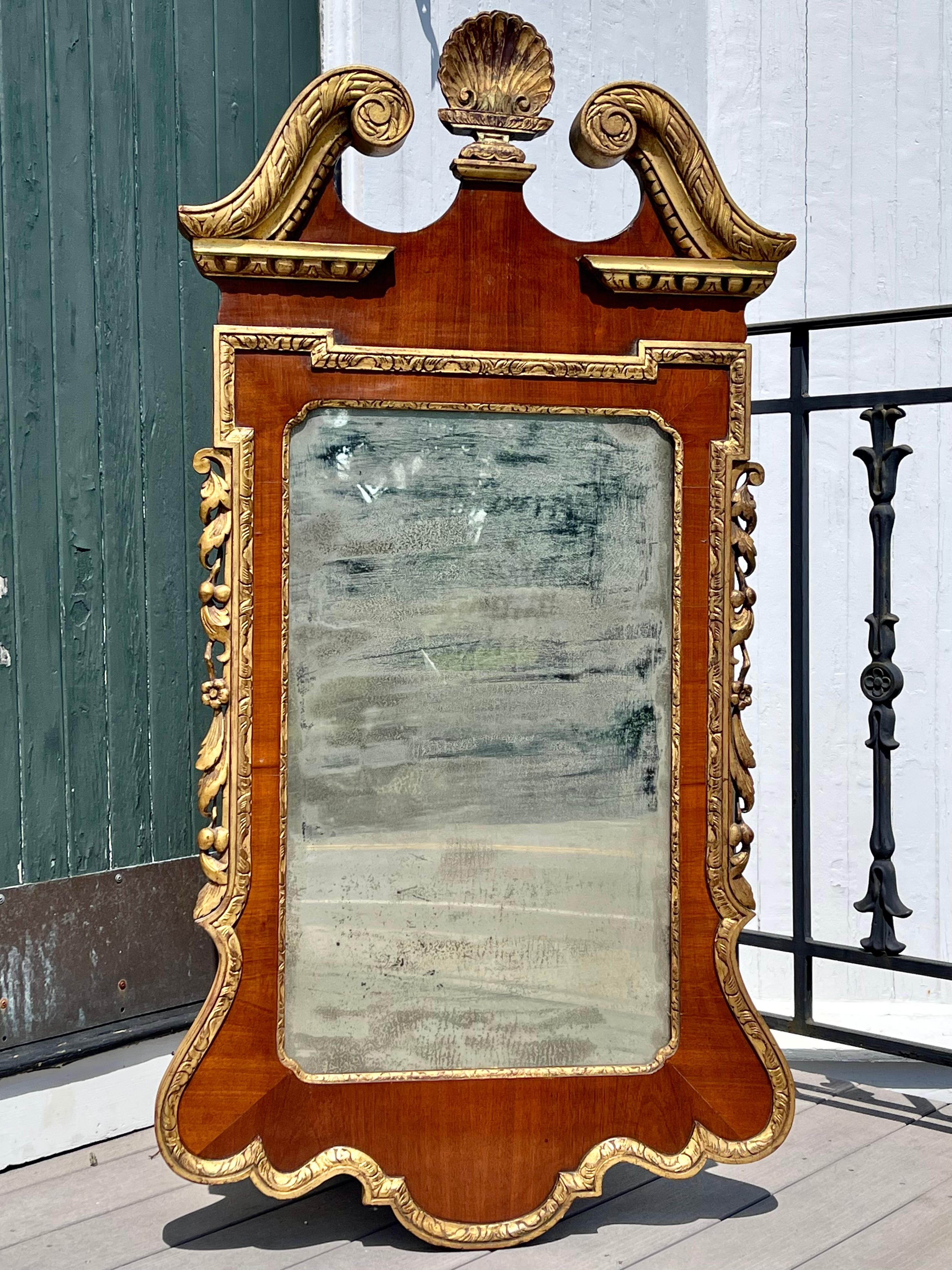 Fine 19th century Philadelphia walnut and gilt chippendale pier mirror. Gilt festoons of foliage and fruit flanking a walnut frame trimmed in gilded georgian carving. Shell Carving as finial. Naturally aged mirror plate provides a wonderful period