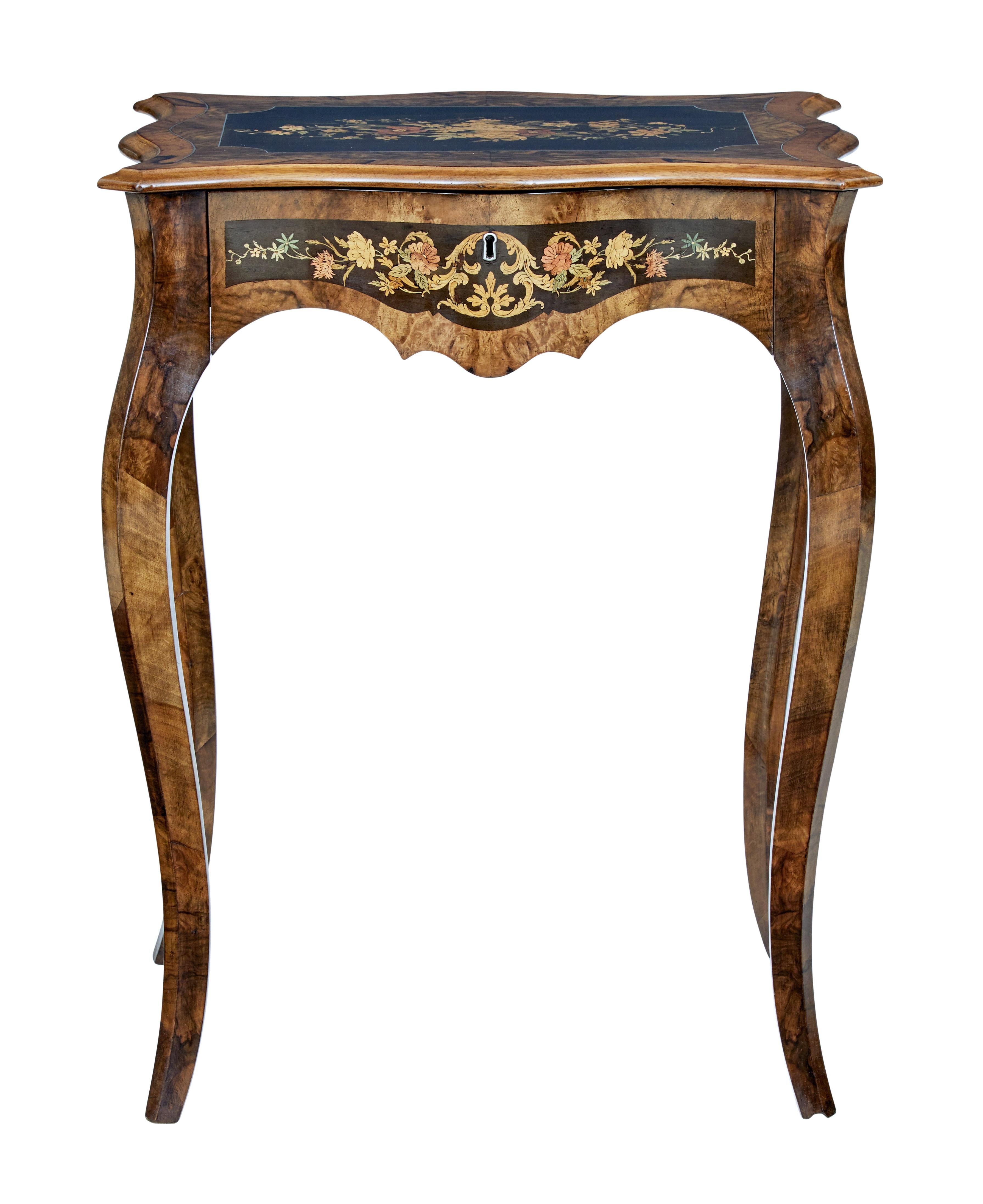 19th century walnut and inlaid work table, circa 1880.

Beautiful inlaid walnut work table with fitted drawer. Serpentine shaped on all 4 sides. Stained black cartouche shaped central panel, beautifully inlaid boxwood, tulipwood and birch,