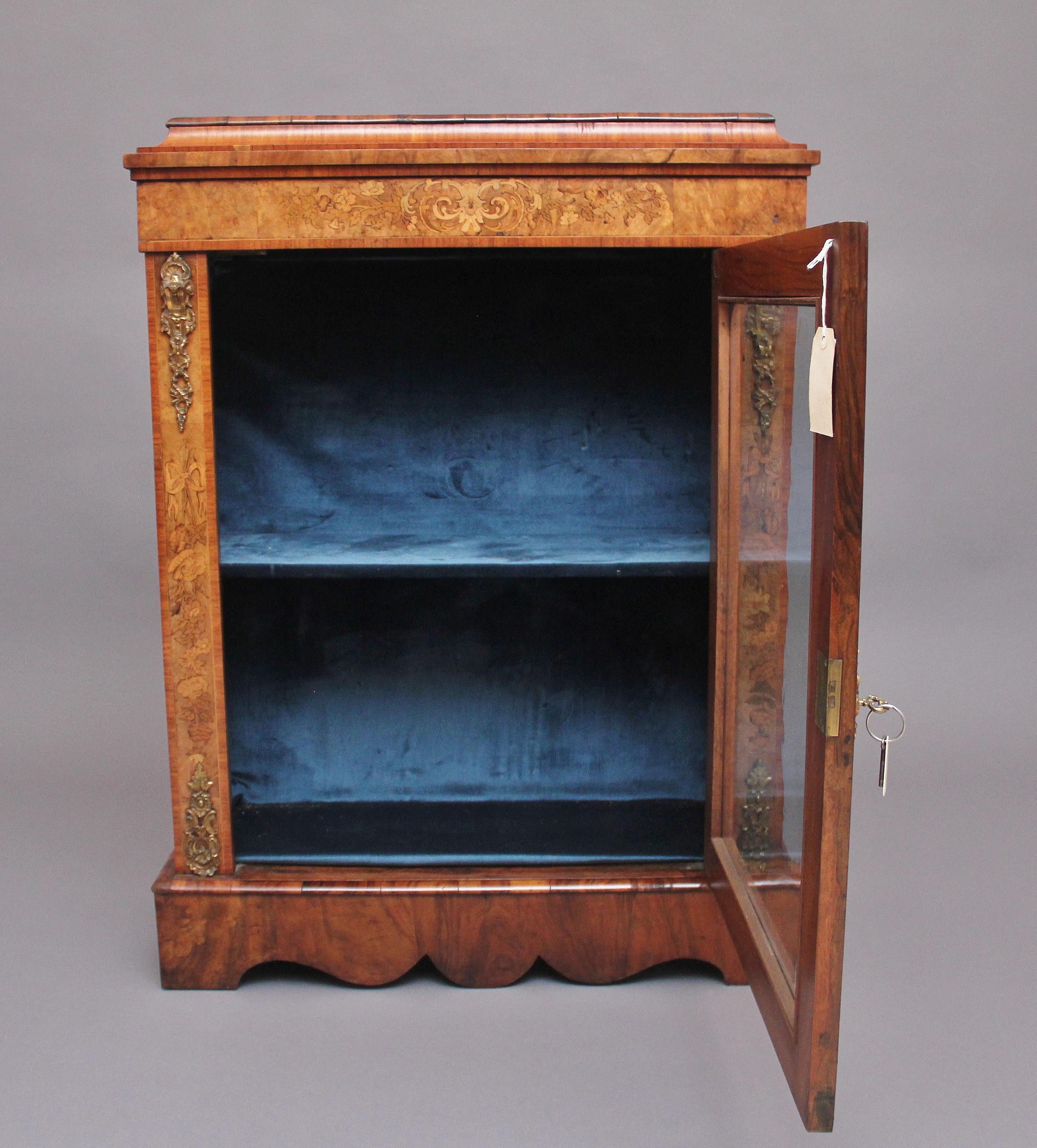 19th century walnut and marquetry pier cabinet, having a nice figured stepped and moulded edge top above a marquetry inlaid frieze with decorative floral inlay, a single door below opening to reveal a blue velvet lined interior with a fixed single