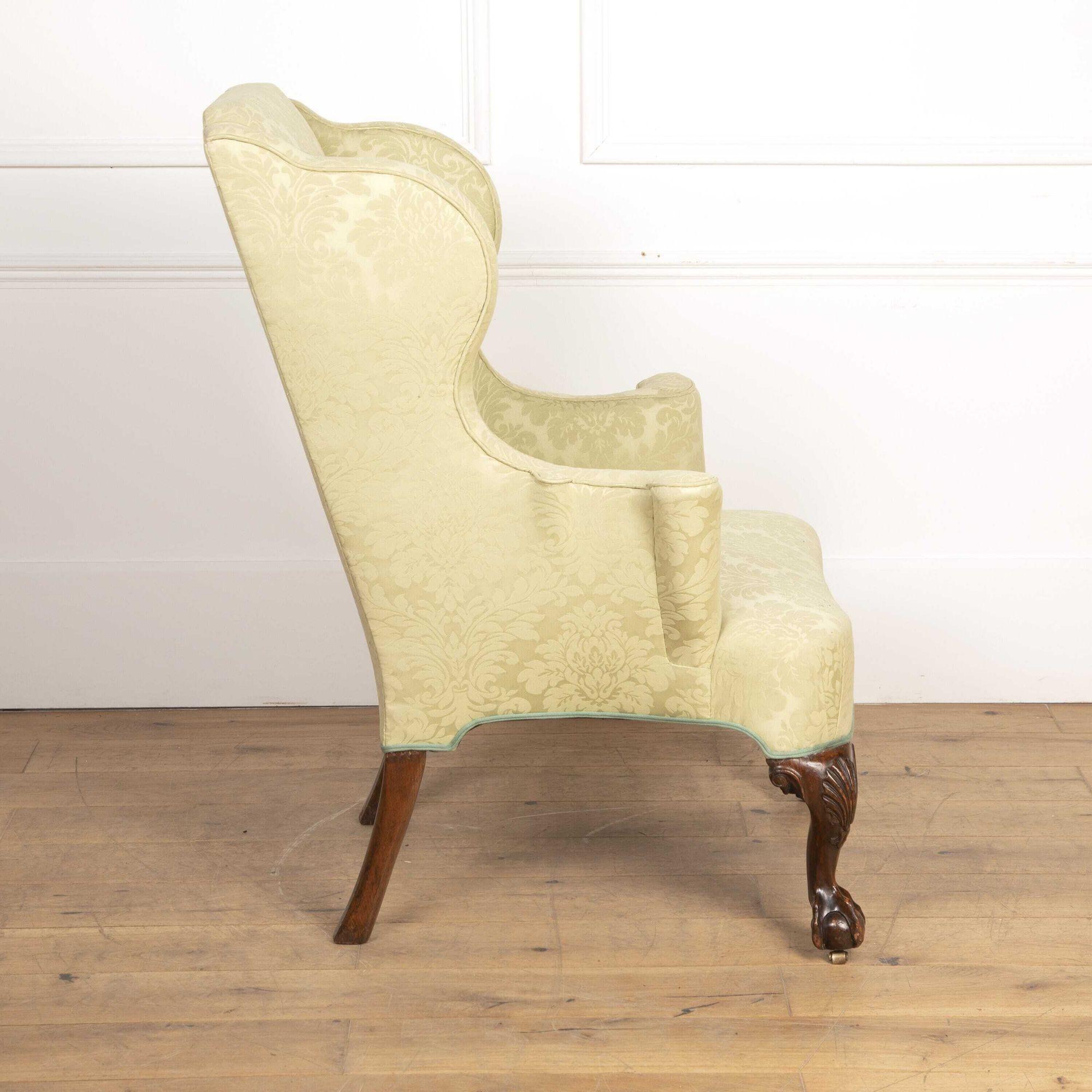 Fine quality 19th century walnut wing chair of classical form. 
This chair has been fully upholstered with deep wings and shaped sides running down into the out-scrolled arms on either side of the padded back and seat with shaped rail below.
The
