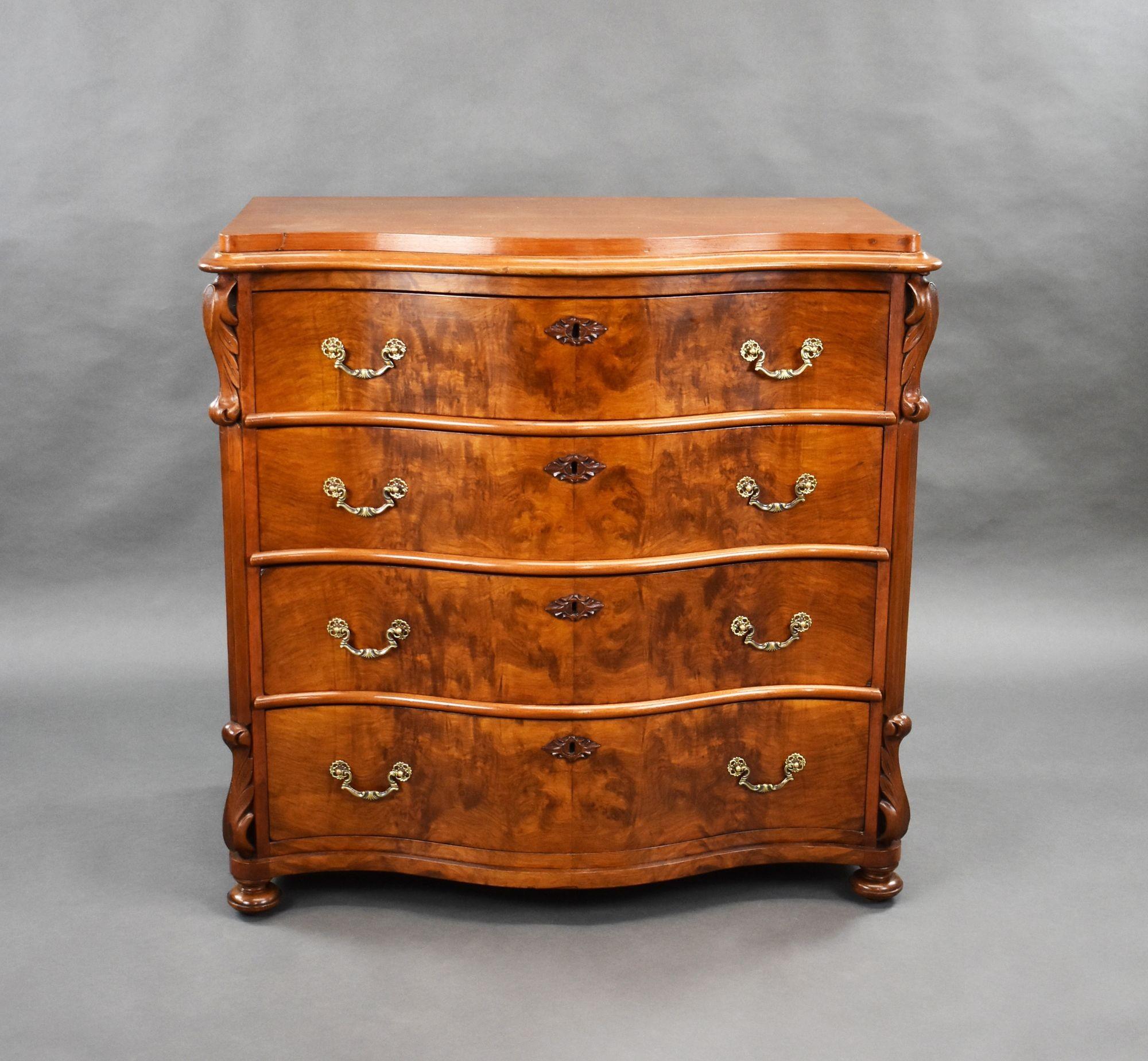 For sale is a good quality 19th century walnut biedermeier serpentine chest of drawers. Having an arrangement of four drawers, each with brass handles, flanked by floral brackets to the top and the base, the chest stands on bun feet and is in very