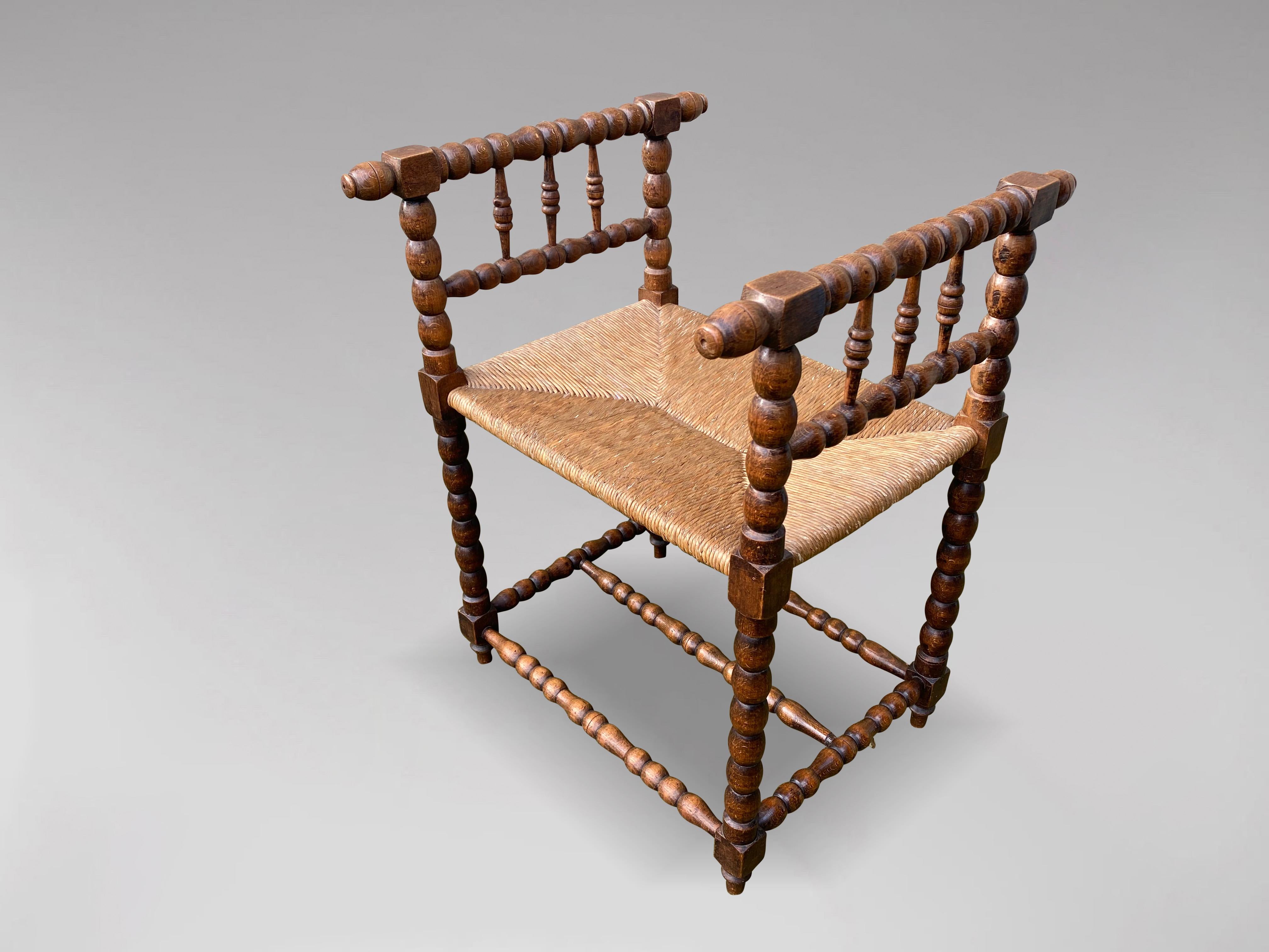 A very ornate late 19th century walnut turned bobbin and rush seat stool or armchair. Beautifully turned bobbin frame with triple stretchers.

The dimensions are:
Height: 75cm (29.5in)
Width: 55cm (21.7in)
Depth: 53cm (20.9in)

Comfortable